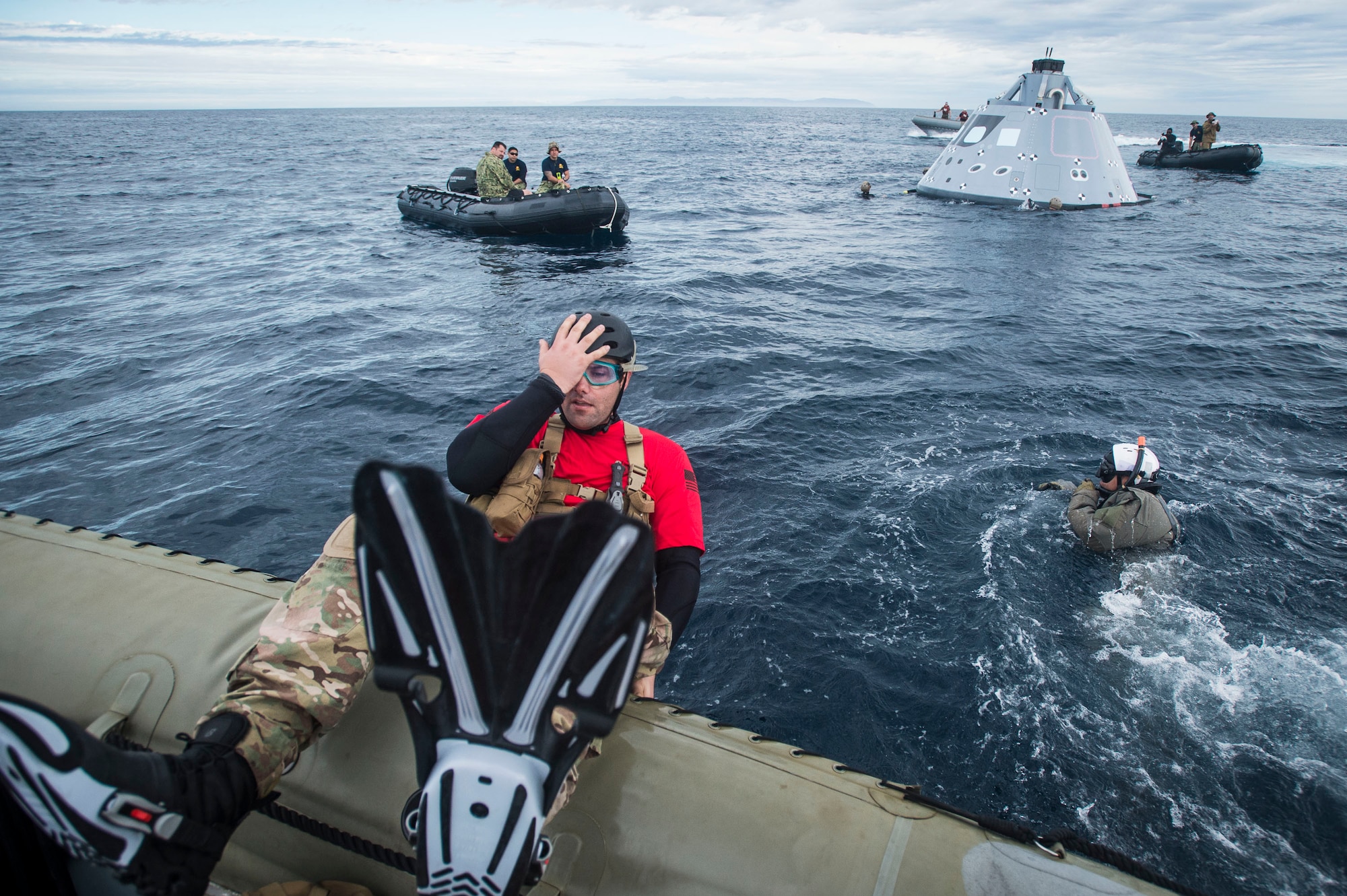 Tech Sgt. Shane Brickey, assigned to the 88th Test and Evaluation Squadron (53rd Wing, Air Combat Command), dives in the Pacific Ocean to retrieve a boilerplate-testing article, belonging to NASA’s Orion Program, Oct. 28, 2016. USS San Diego (LPD 22) is currently conducting recovery operations with NASA’s Orion Program; testing a new towing technique utilizing NASA and Naval technology with the goal of reducing manning and increasing safety. (U.S. Navy Combat Camera Photo by Petty Officer 1st Class Torrey W. Lee)