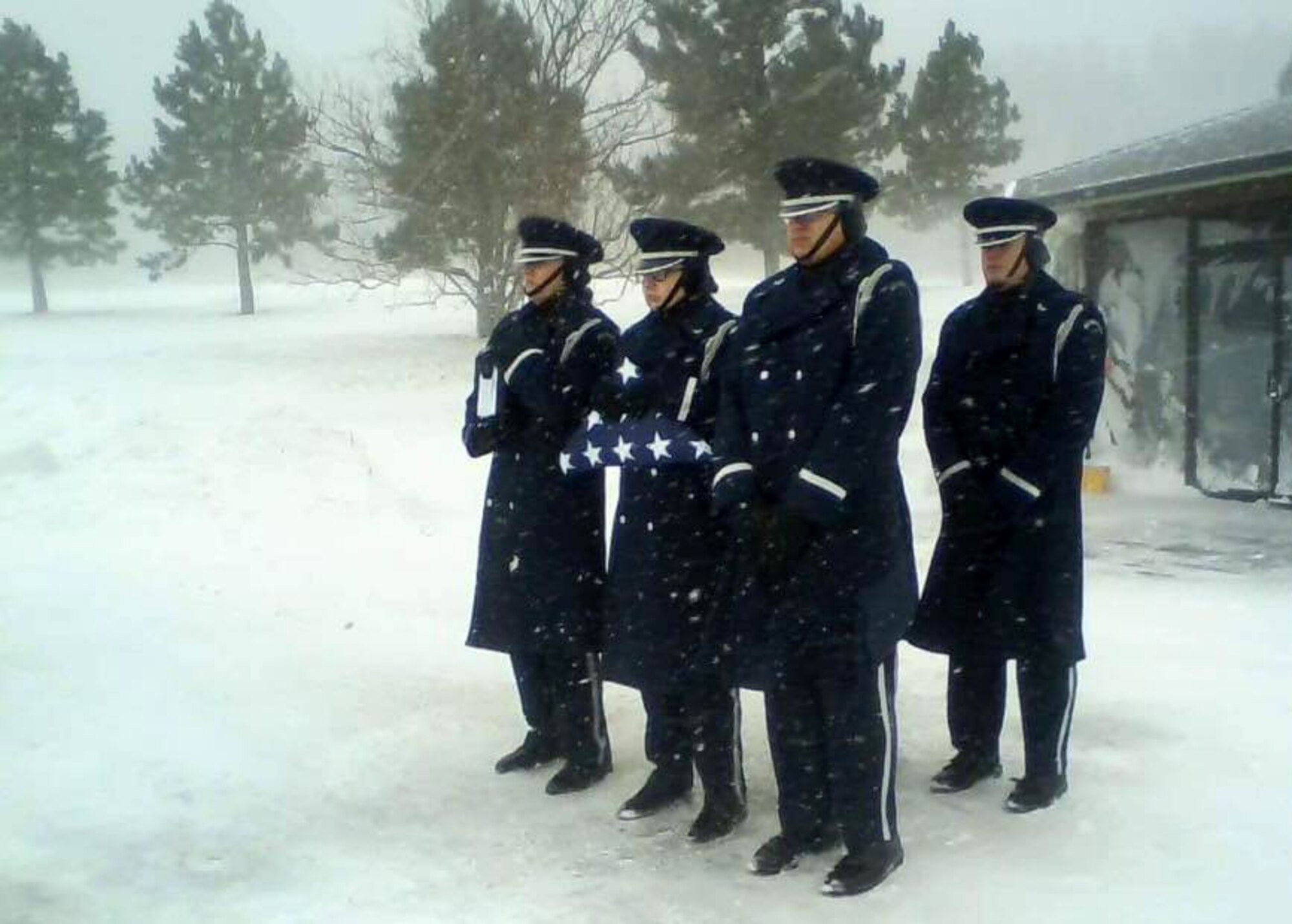 Airmen from the Ellsworth Air Force Base Honor Guard conduct a burial ceremony for a veteran during a winter storm at the Black Hills National Cemetery in Sturgis, S.D., Nov. 29, 2016. The primary mission of the honor guard is to provide full military funeral honors to our veterans, retirees and active-duty personnel. In total, seven Airmen were required at the cemetery to properly conduct the full retiree ceremony, which is as a solemn act of recognition and remembrance by a grateful nation for dedicated service and sacrifices. (Courtesy photo)