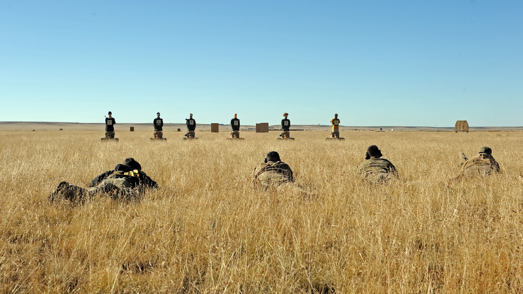 Members of the 27th Special Operations Civil Engineer Squadron Explosive Ordnance Disposal flight zero their weapons prior to conducting live fire training utilizing state-of-the-art Robotic Human Type Targets, Nov. 8, 2016, at Melrose Air Force Range, N.M. RHTT targets are autonomous and smart in nature, allowing for the creation of infinite realistic scenarios which call for Air Commandos to employ elevated tactical thought processes, and execute appropriate courses of action with real-time urgency. (U.S. Air Force photo by Staff Sgt. Whitney Amstutz/Released)
