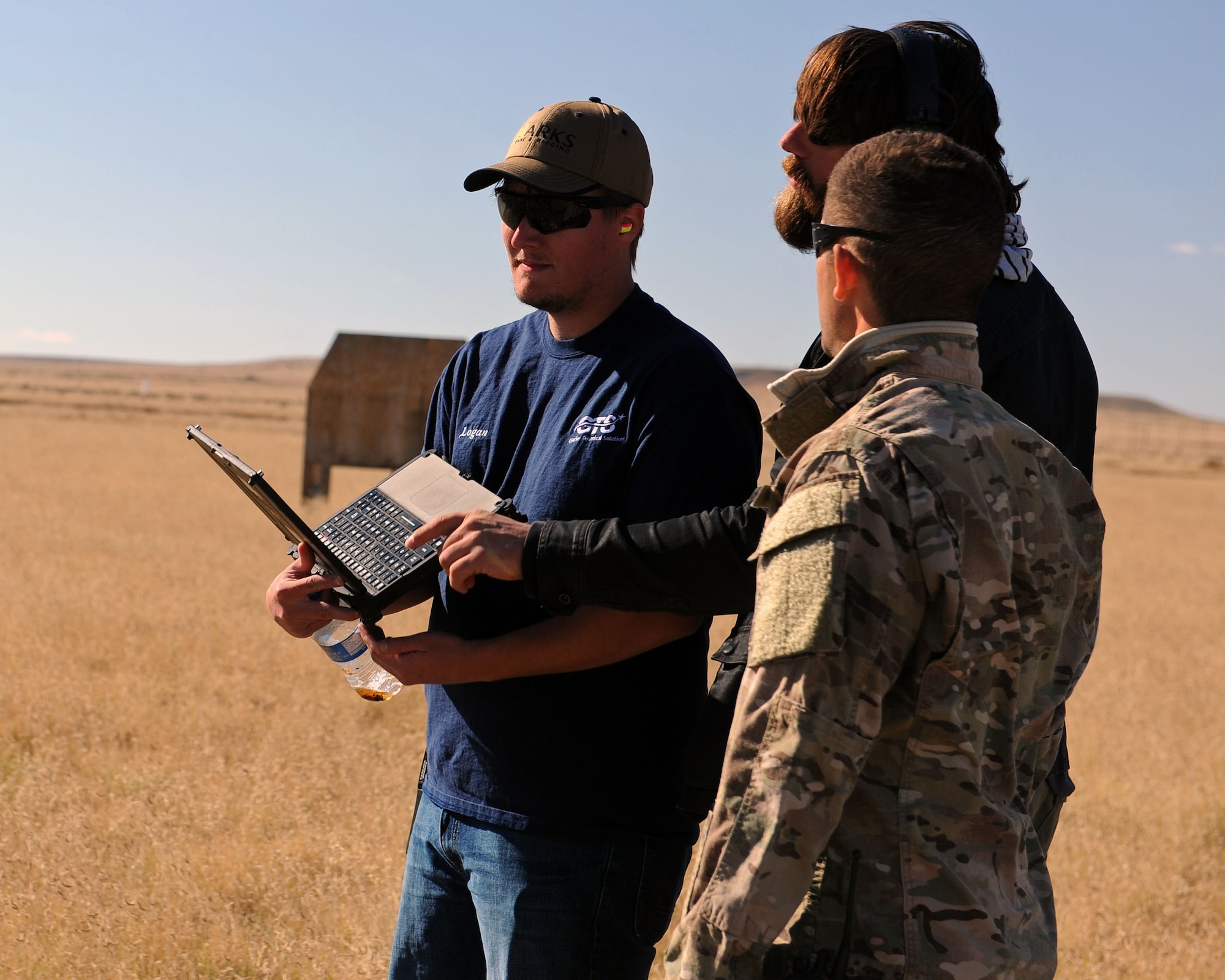 A member of the 27th Special Operations Civil Engineer Squadron Explosive Ordnance Disposal flight discusses training scenarios with members of the Robotic Human Type Targets team during live fire training Nov. 8, 2016, at Melrose Air Force Range, N.M. RHTT targets are autonomous and smart in nature, allowing for the creation of infinite realistic scenarios which call for Air Commandos to employ elevated tactical thought processes, and execute appropriate courses of action with real-time urgency. (U.S. Air Force photo by Staff Sgt. Whitney Amstutz/Released)