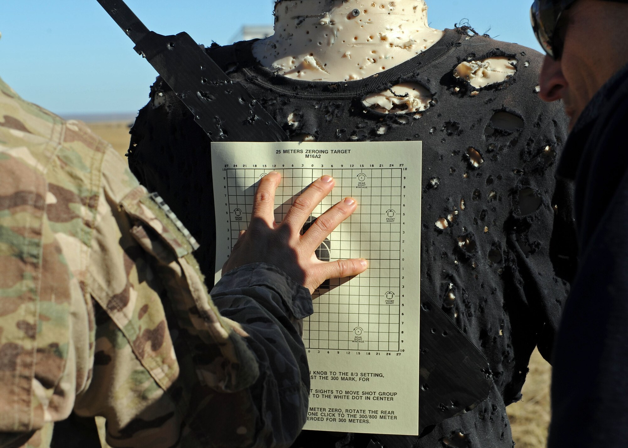 A member of the 27th Special Operations Civil Engineer Squadron Explosive Ordnance Disposal flight adheres a sighting target to a Robotic Human Type Target prior to conducting live fire training Nov. 8, 2016, at Melrose Air Force Range, N.M. RHTT targets are autonomous and smart in nature, allowing for the creation of infinite realistic scenarios which call for Air Commandos to employ elevated tactical thought processes, and execute appropriate courses of action with real-time urgency. (U.S. Air Force photo by Staff Sgt. Whitney Amstutz/Released)