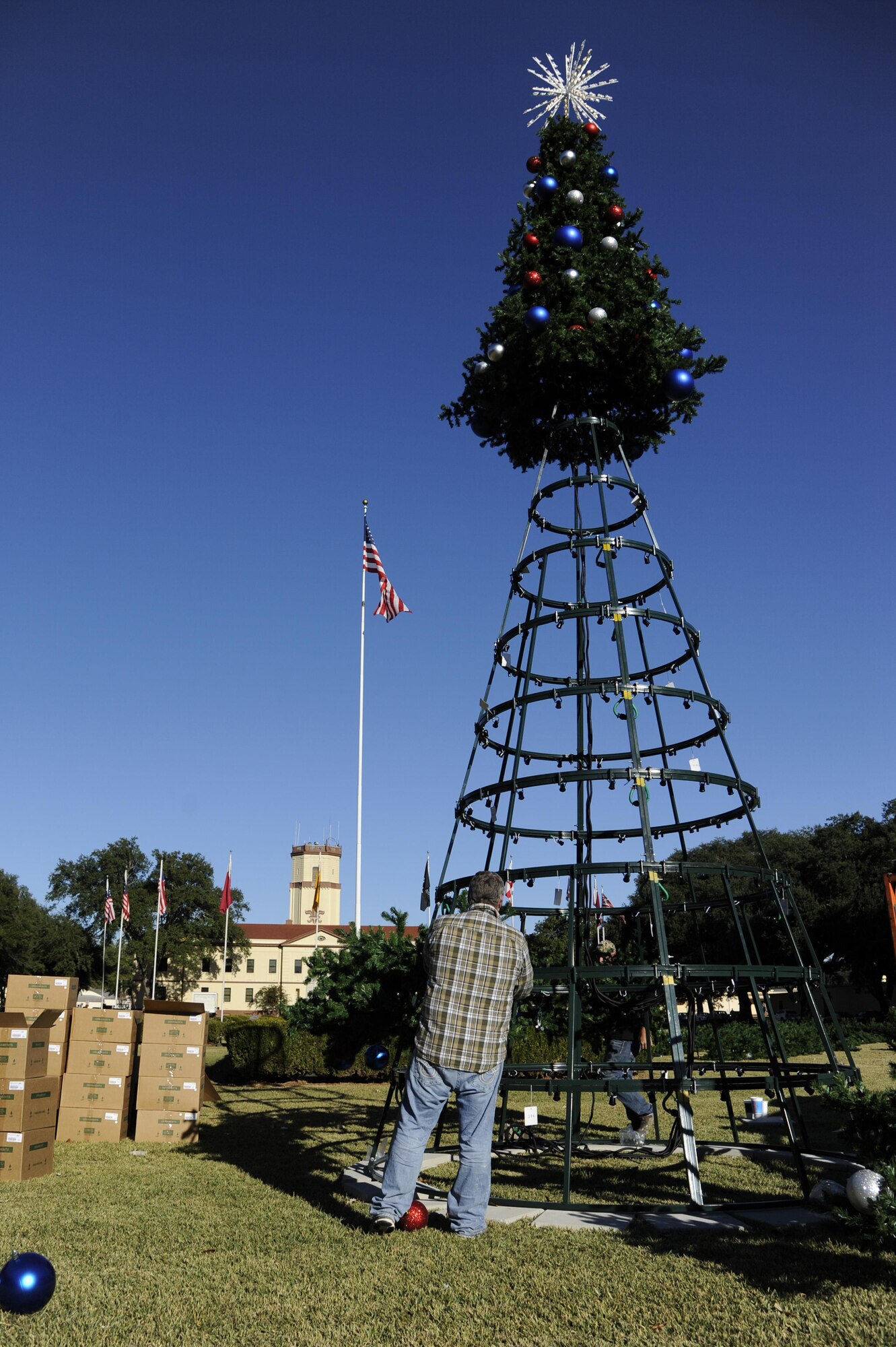 Michael Wynne places ornaments on a tree limb to be hung on the Christmas tree in front of 2nd Bomb Wing headquarters at Barksdale Air Force Base, La., Nov. 30, 2016. The chapel will be hosting a tree lighting event on Dec. 8 to kick-off the holiday season. (U.S. Air Force photo/Staff. Sgt. Joseph A. Pagán Jr.)