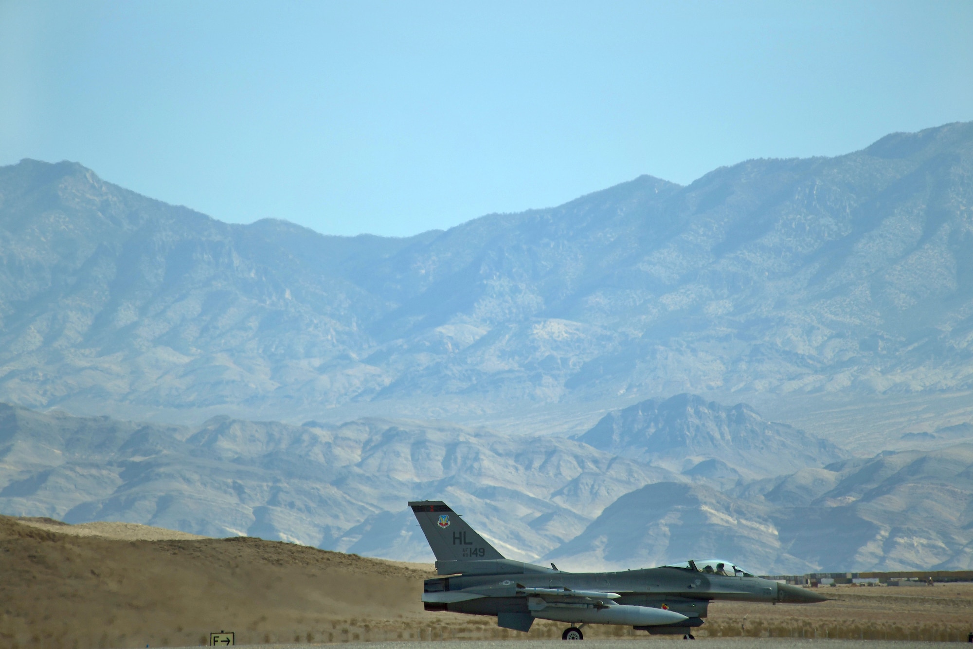 An F-16 Fighting Falcon taxis down the flightline Nov. 15, 2016, at Creech Air Force Base, Nev. Two F-16 pilots flew from Nellis AFB to Creech AFB to assist in the certification of the aircraft arresting system, a system used to rapidly slow down aircraft during emergency situations.  (U.S. Air Force photo by Airman 1st Class James Thompson)