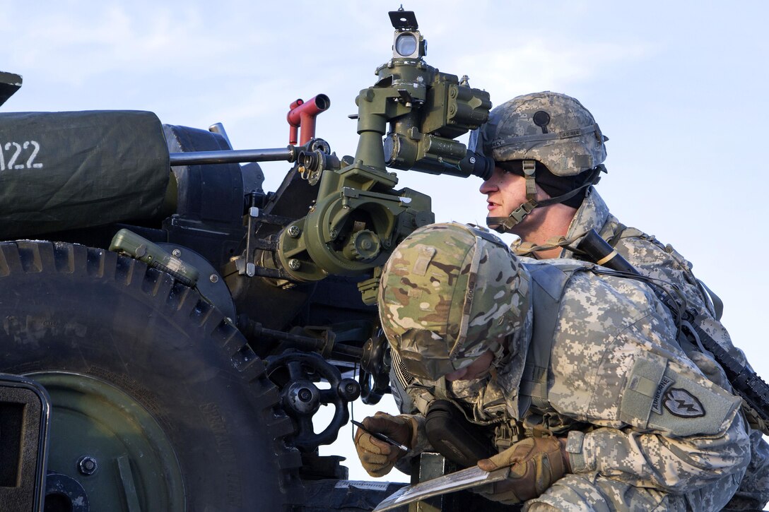 Paratroopers sight in a 105 mm howitzer during live-fire training at Joint Base Elmendorf-Richardson, Alaska, Nov. 22, 2016. After dropping two heavy equipment pallets, each holding a 105 mm howitzer, paratroopers assigned to the 25th Infantry Division’s 2nd Battalion, 377th Parachute Field Artillery Regiment, conducted a live-fire training exercise. Air Force photo by Alejandro Pena