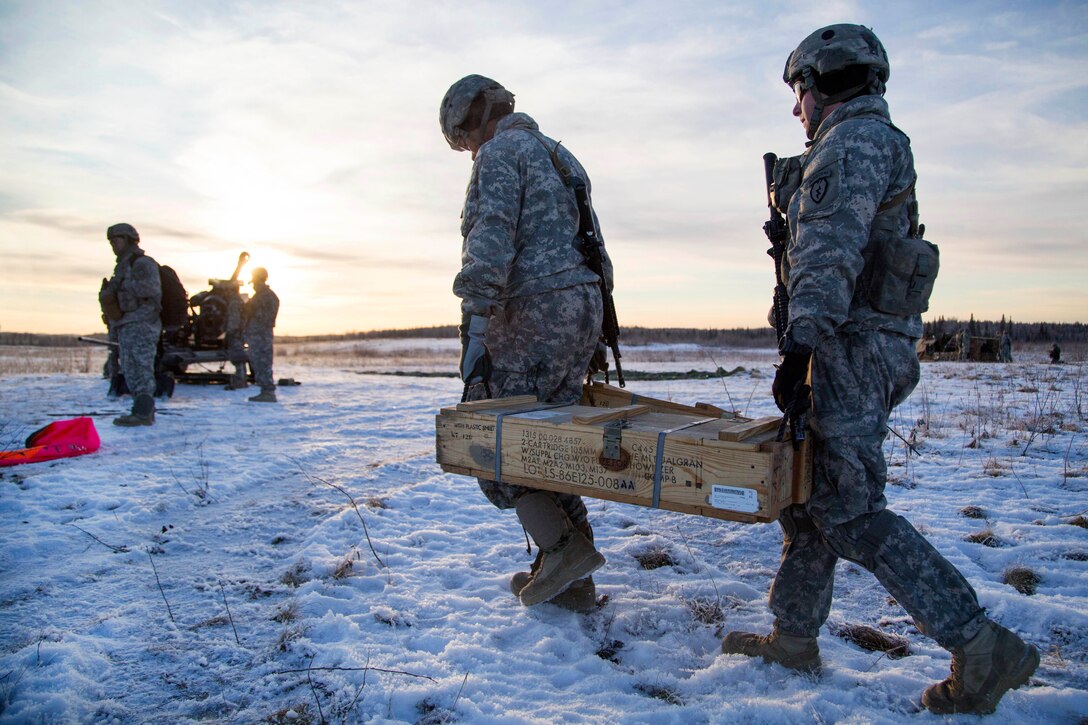 Soldiers move crates of 105 mm high-explosive rounds during live-fire training at Joint Base Elmendorf-Richardson, Alaska, Nov. 22, 2016. Air Force photo by Alejandro Pena