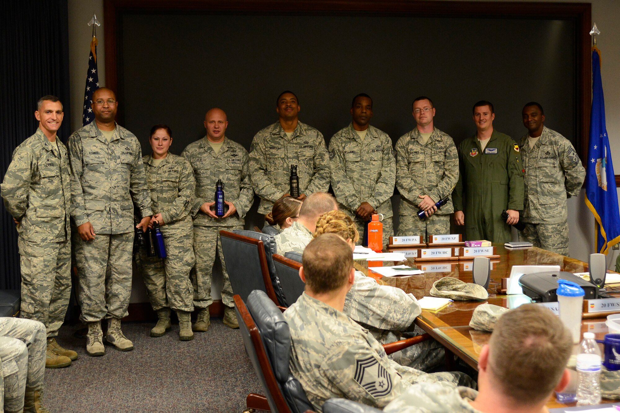 U.S. Airmen from the 20th Equipment Maintenance Squadron are recognized by Col. Daniel Lasica, 20th Fighter Wing commander, right, and Chief Master Sgt. Christopher McKinney, 20th FW command chief, left, at Shaw Air Force Base, S.C., Nov. 30, 2016. Airmen from the 20th EMS added decals to a scale model of an F-16CM Fighting Falcon in front of the 20th FW headquarters building so it more closely resembles the F-16s currently assigned to Shaw. (U.S. Air Force photo by Airman 1st Class BrieAnna Stillman)