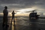 In this file photo, Chief Petty Officer Kurt Bartholamai acts as safety officer while Chief Petty Officer Jed May directs personnel aboard the flight deck of littoral combat ship USS Coronado (LCS 4). Currently on a rotational deployment in support of the Asia-Pacific Rebalance, Coronado is a fast and agile warship tailor-made to patrol the region’s littorals and work hull-to-hull with partner navies, providing 7th Fleet with the flexible capabilities it needs now and in the future. 