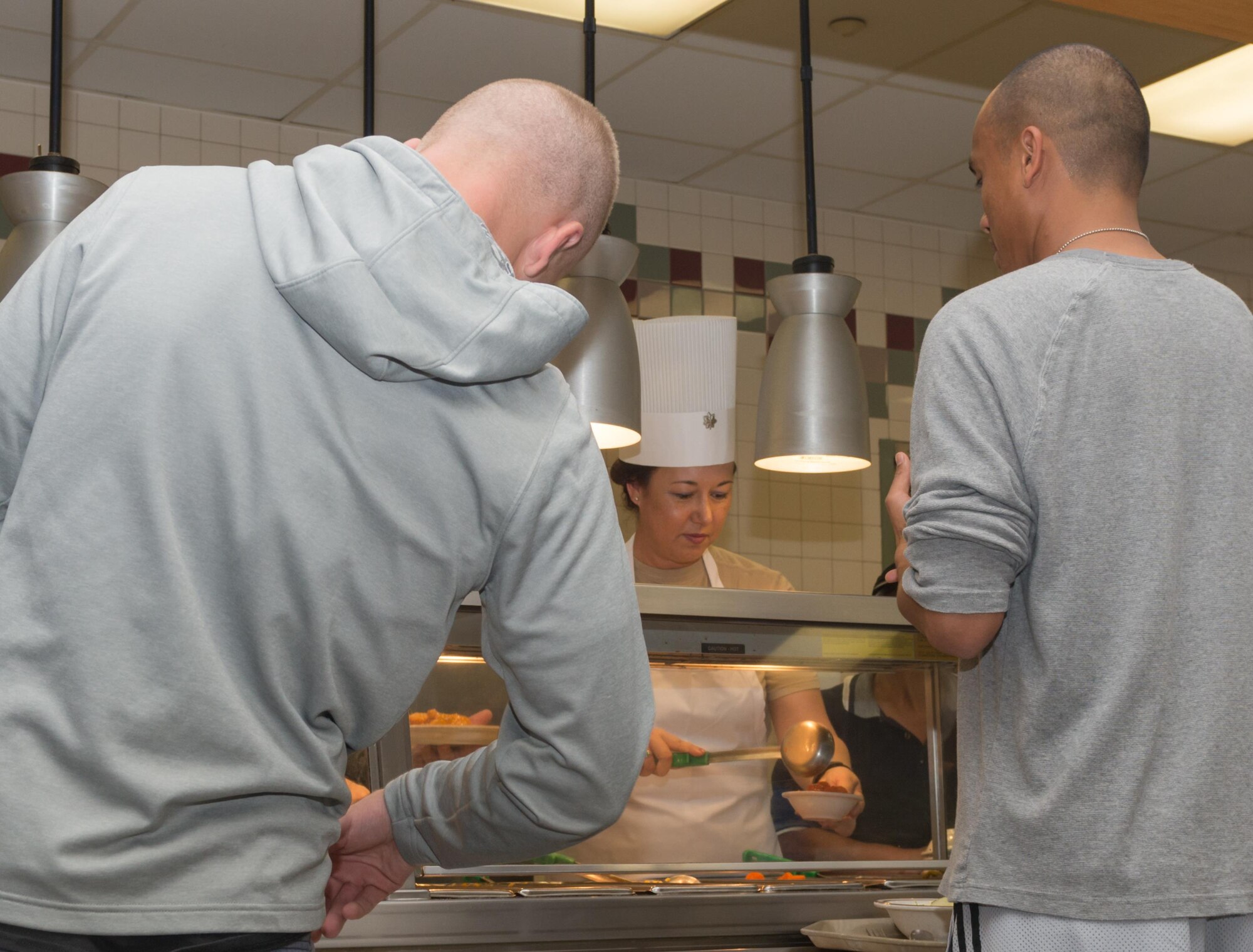 Lt. Col. Elisabeth Aptekar, 335th Training Squadron commander, prepares food for Airmen at the Azalea Dining Facility, Nov. 24, 2016, on Keesler Air Force Base, Miss. It is tradition at Keesler for commanders, first sergeants and superintendents to serve a Thanksgiving meal at the dining facility to technical training and permanent party Airmen who are not able to go home for the holiday weekend. (U.S. Air Force photo by Andre’ Askew)