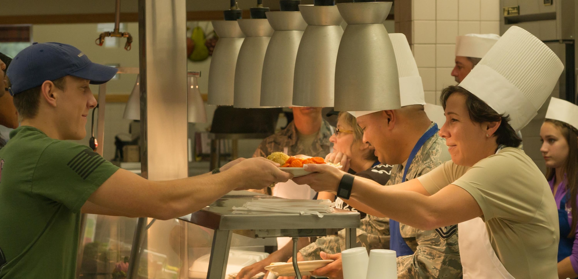 Airman Austin Salyers, 336th Training Squadron, receives his holiday meal from Col. Jeannine Ryder, 81st Medical Group commander, at the Azalea Dining Facility, Nov. 24, 2016, on Keesler Air Force Base, Miss. It is tradition at Keesler for commanders, first sergeants and superintendents to serve a Thanksgiving meal at the dining facility to technical training and permanent party Airmen who are not able to go home for the holiday weekend. (U.S. Air Force photo by Andre’ Askew)