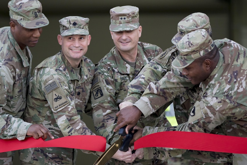 Senior leaders from the U.S. Army Sustainment Command and the 401st Army Field Support Brigade cut a ribbon to celebrate the opening of several new equipment warehouses Nov. 17, 2016 at Camp Arifjan, Kuwait. The warehouses, designed and built by the U.S. Army engineers with the support of the Kuwait government, will store and protect Army equipment. (U.S. Army photo by Sgt. Angela Lorden)