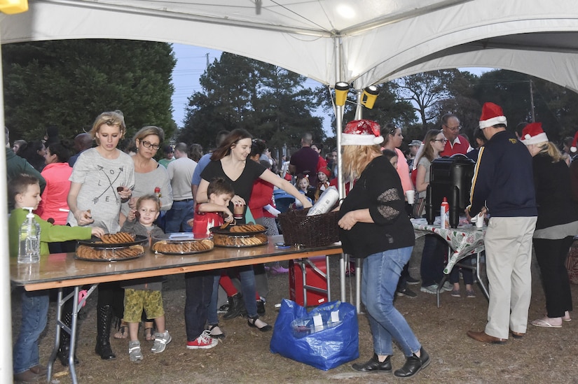 Members of Joint Base Charleston celebrate the start of the holiday season with the annual holiday tree lighting Nov. 30, 2016 on the Joint Base Charleston – Air Base. Families and children gathered for caroling, hot chocolate, photos with Santa and the lighting of the holiday tree on base.