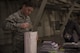 Airman Paul Booth, 92nd Aircraft Maintenance Squadron crew chief, places a notepad into a care package Dec. 1, 2016 at Fairchild Air Force Base. Booth volunteered to fill shipping boxes with various items such as soap, hot sauce, wet wipes and beef jerky. The boxes were packed as part of KREM 2 News Treats 2 Troops program that provides deployed military members with care packages. (U.S. Air Force photo/Senior Airman Nick J. Daniello)