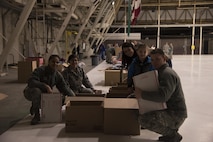 Team Fairchild volunteers pack items into care packages as part of KREM 2 News Treats 2 Troops program Dec. 1, 2016 at Fairchild Air Force Base. Volunteers packaged more than 400 boxes that will be delivered to deployed military members. The boxes are filled with various items, such as hot sauce, wet wipes, beef jerky, toothbrushes, and magazines. (U.S. Air Force photo/Senior Airman Nick J. Daniello)