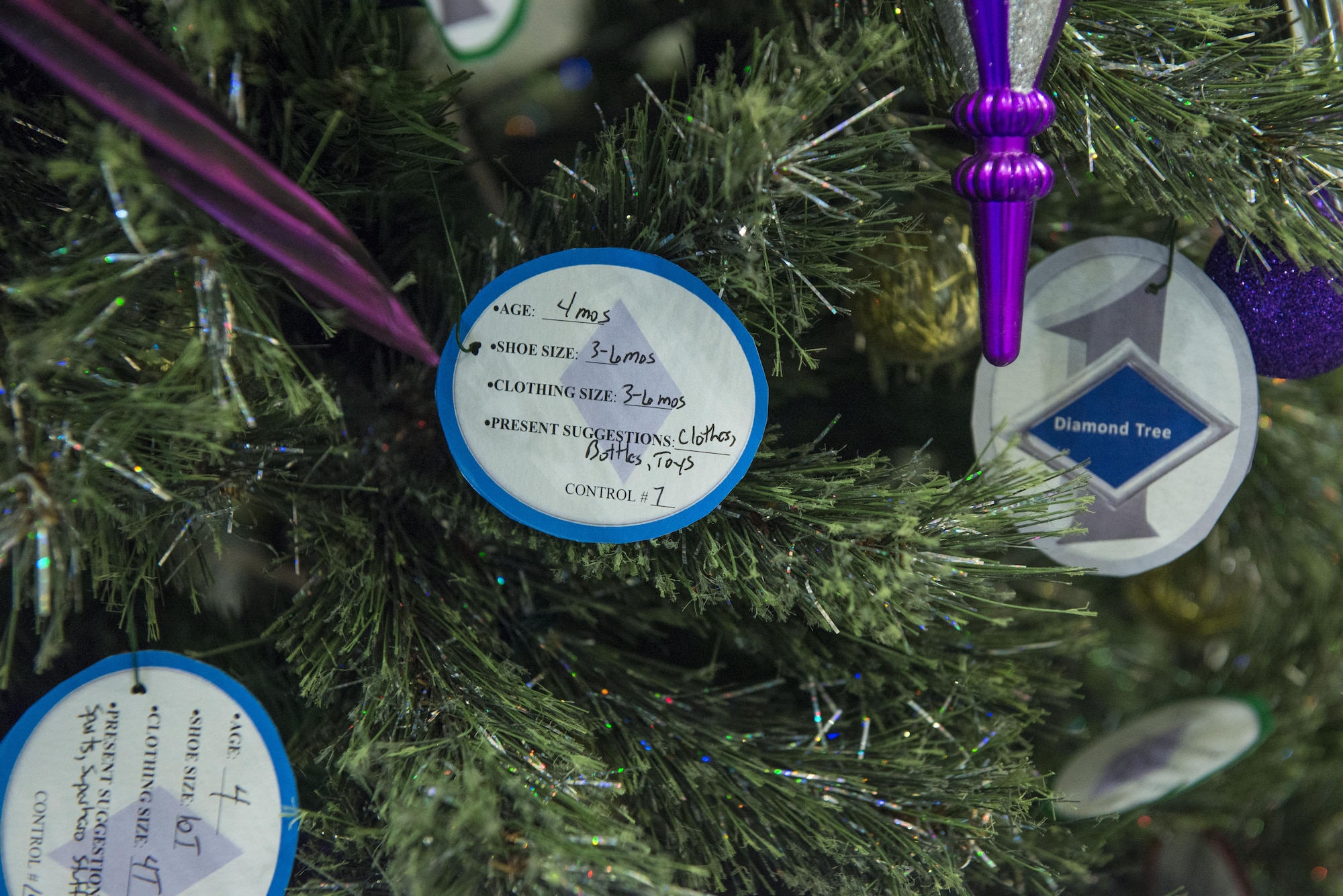 Paper ornaments adorn Holloman’s first sergeant Diamond Tree inside the Base Exchange at Holloman Air Force Base, N.M. on Nov. 29, 2016. The Diamond Tree program offers assistance to low income and junior enlisted families who are not able to afford Christmas gifts for their children. (U.S. Air Force photo by Airman 1st Class Alexis P. Docherty) 