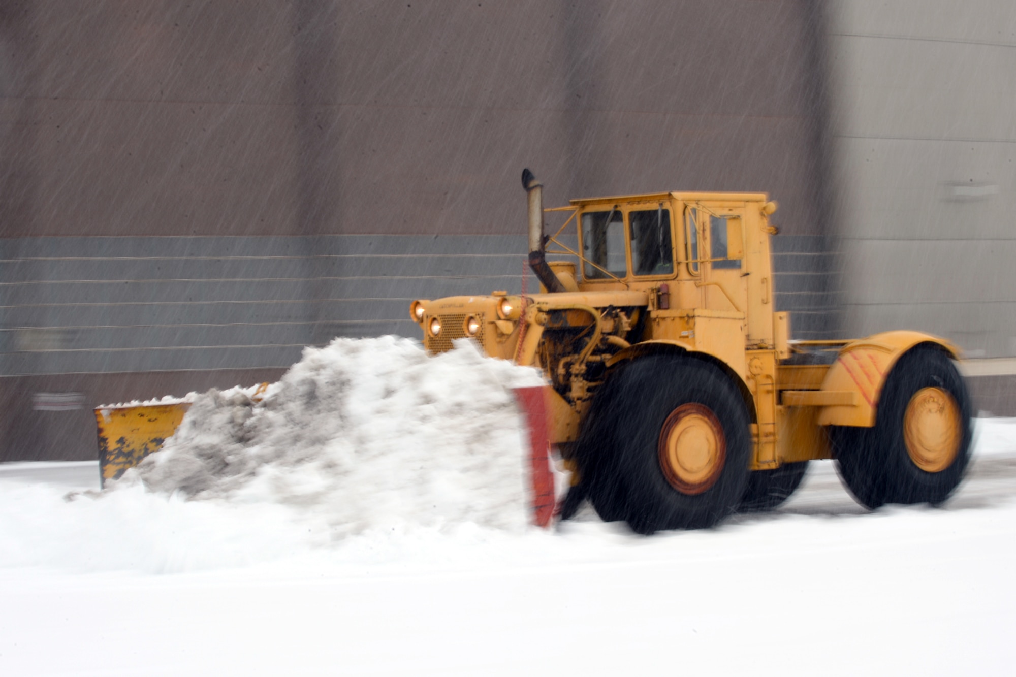 Personnel and equipment assigned to the 75th Civil Engineer Squadron remove heavy, wet snow from the Hill Air Force Base flightline and industrial-area roadways Nov. 28. According to the 75th Operations Support Squadron Weather Flight, the storm bought 7 inches of snow to Hill, the first significant snow event of the winter season. (U.S. Air Force photos by Todd Cromar)