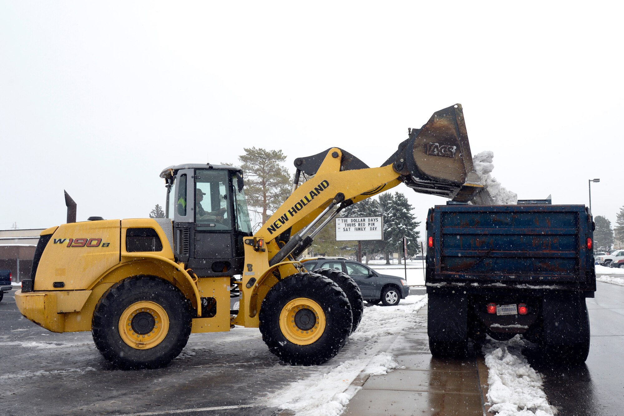 Personnel and equipment assigned to the 75th Civil Engineer Squadron remove snow from a Hill Air Force Base parking lot, Dec. 1. (U.S. Air Force photos by Todd Cromar)