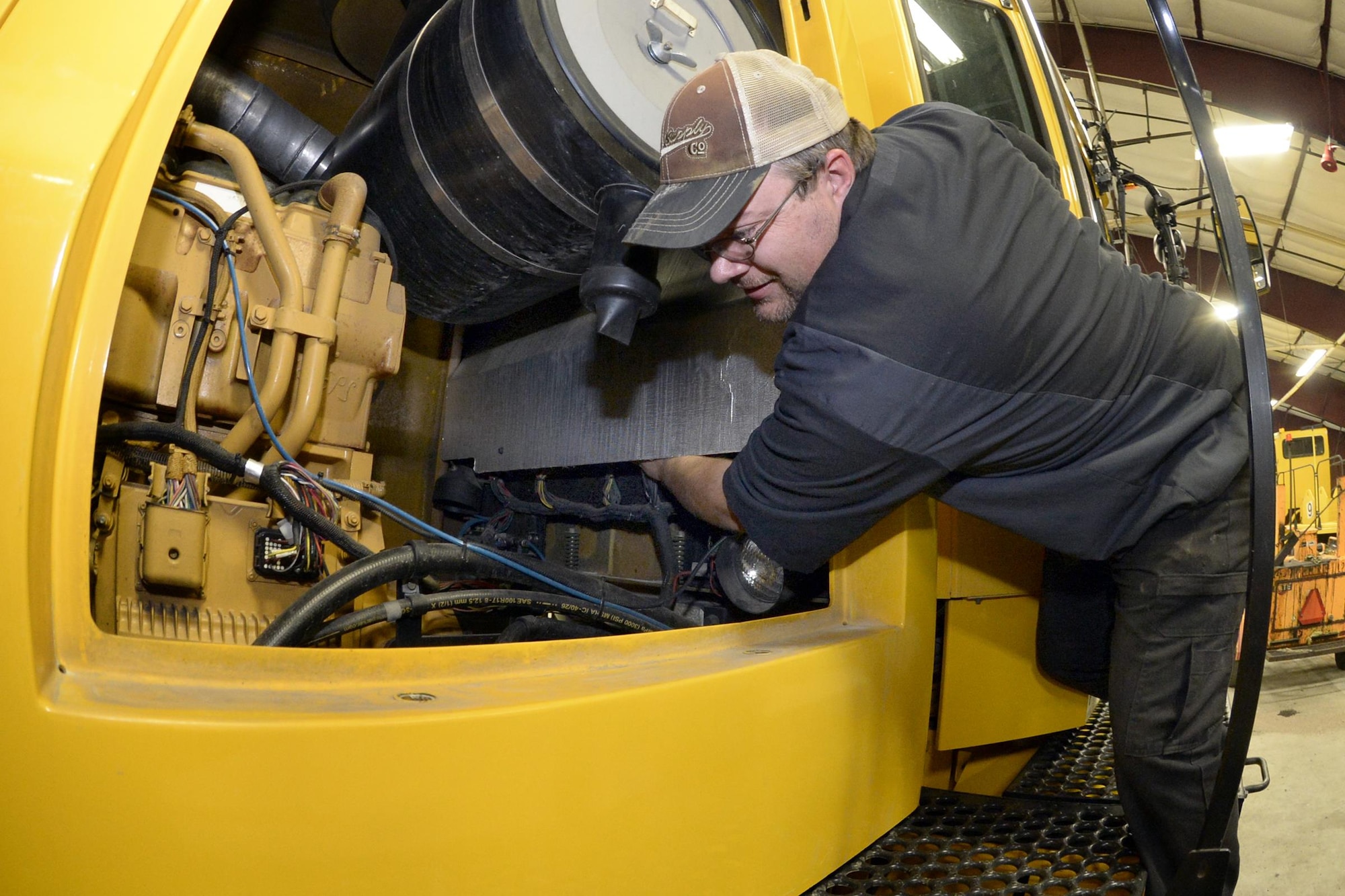 Tom Giles, 75th Logistics Readiness Squadron, performs maintenance on a blower truck in the snow barn at Hill Air Force Base, Dec. 1. These trucks and other snow removal vehicles are kept in top shape to fulfill their mission of keeping the airfield here operational during any weather conditions. (U.S. Air Force photos by Todd Cromar)