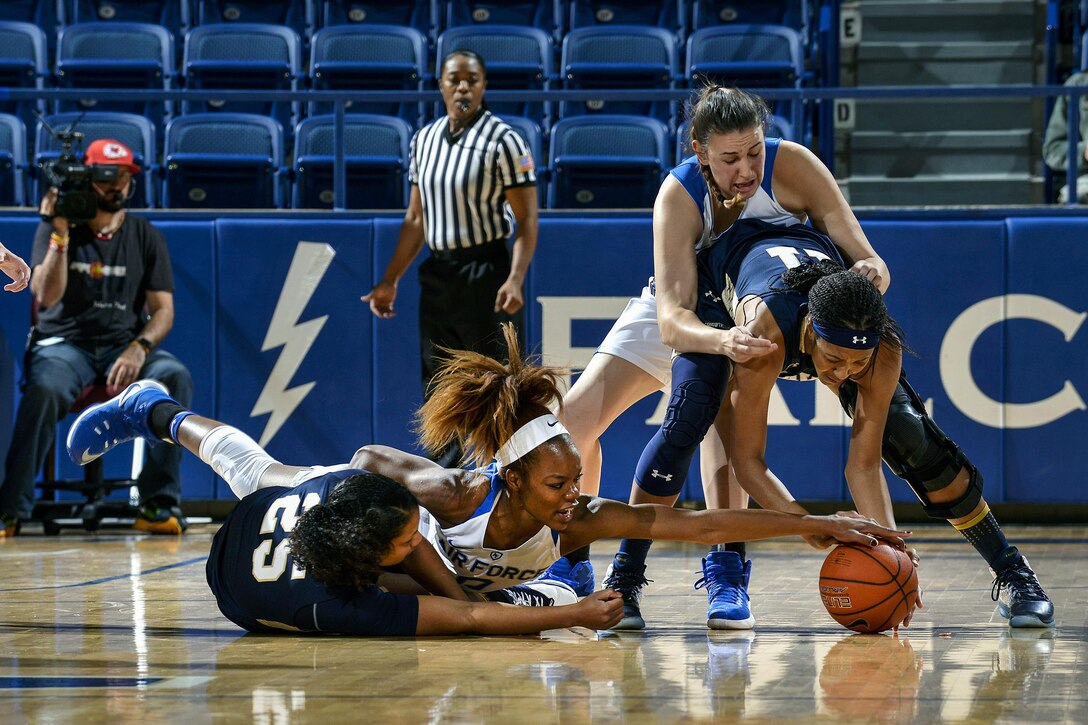 Dee Bennett, a junior, battles for the ball as Air Force hosted Navy at the U.S. Air Force Academy in Colorado Springs, Colo., Nov. 29, 2016.  The Midshipmen defeated the Falcons, 64-46. Air Force photo by Jason Gutierrez