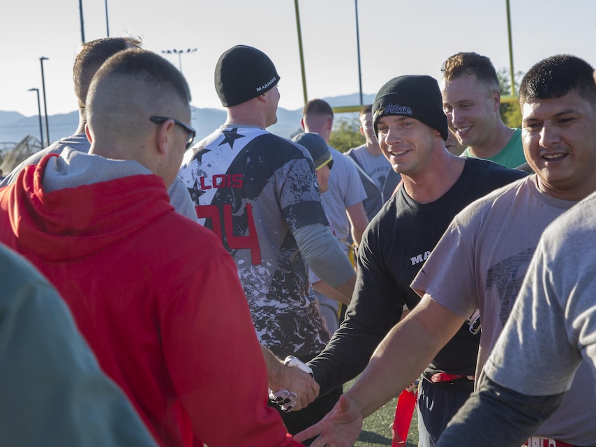 Staff noncommissioned officers and officers of Marine Wing Support Squadron 374 shake hands after the MWSS-374 Turkey Bowl at Felix Field aboard the Marine Corps Air Ground Combat Center, Twentynine Palms, Calif., Nov. 22, 2016. MWSS-374 held the Turkey Bowl to build camaraderie within the senior leadership. (Official Marine Corps photo by Lance Cpl. Dave Flores/Released)