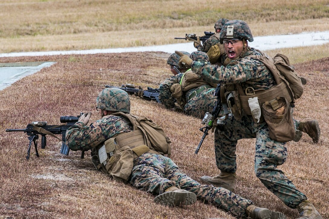 A Marine gives a command to engaging targets during a fire and maneuver range at Camp Lejeune, N.C., Nov. 29, 2016. The Marines conducted the training to sharpen fundamentals and increase combat readiness.The Marine is assigned to 1st Battalion, 8th Marine Regiment. Marine Corps photo by Lance Cpl. Damarko Bones