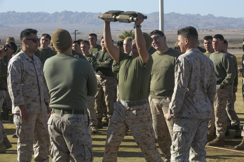 Lance Cpl. Minhyung Lee, driver, 1st Tank Battalion, performs military presses with a tank track section as part of a physical training competition during the battalion’s operational pause at Del Valle Field aboard the Marine Corps Air Ground Combat Center, Twentynine Palms, Calif., Nov. 29, 2016. (Official Marine Corps photo by Cpl. Thomas Mudd/Released)
