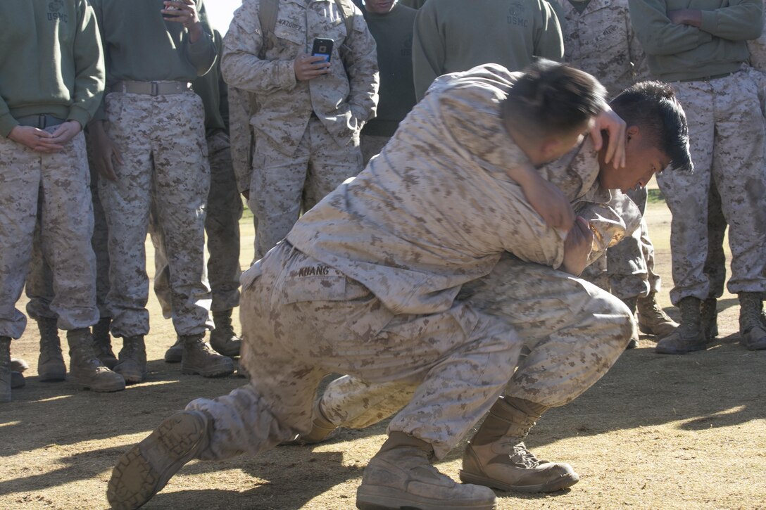 Lance Cpl. Jalille Ryan Cristobal, tank mechanic, and Lance Cpl. Alan Kuang, driver, 1st Tank Battalion, grapple during a physical training competition as part of the battalion’s operational pause at Del Valle Field aboard the Marine Corps Air Ground Combat Center, Twentynine Palms, Calif., Nov. 29, 2016. (Official Marine Corps photo by Cpl. Thomas Mudd/Released)