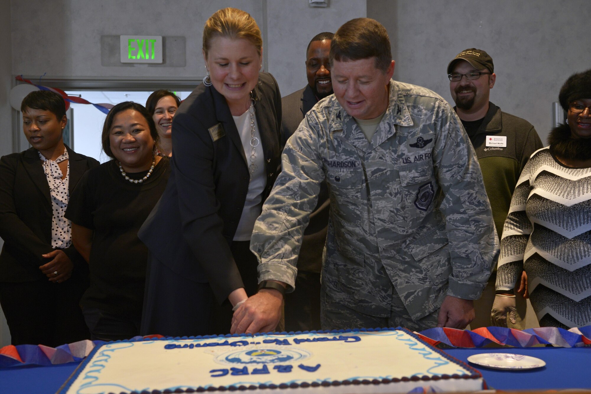 Sonya Meier, Airman & Family Readiness Center chief, left, and Col. Neil Richardson, 374th Airlift Wing vice commander, cut a cake during the grand re-opening ceremony of the AFRC at Yokota Air Base, Japan, Nov. 29, 2016. After being scattered around Yokota and periodically changing locations for the past 18 months, the Airman & Family Readiness Center has come once again become a one-stop center at building 535. (U.S. Air Force photo by Staff Sgt. David Owsianka/Released)