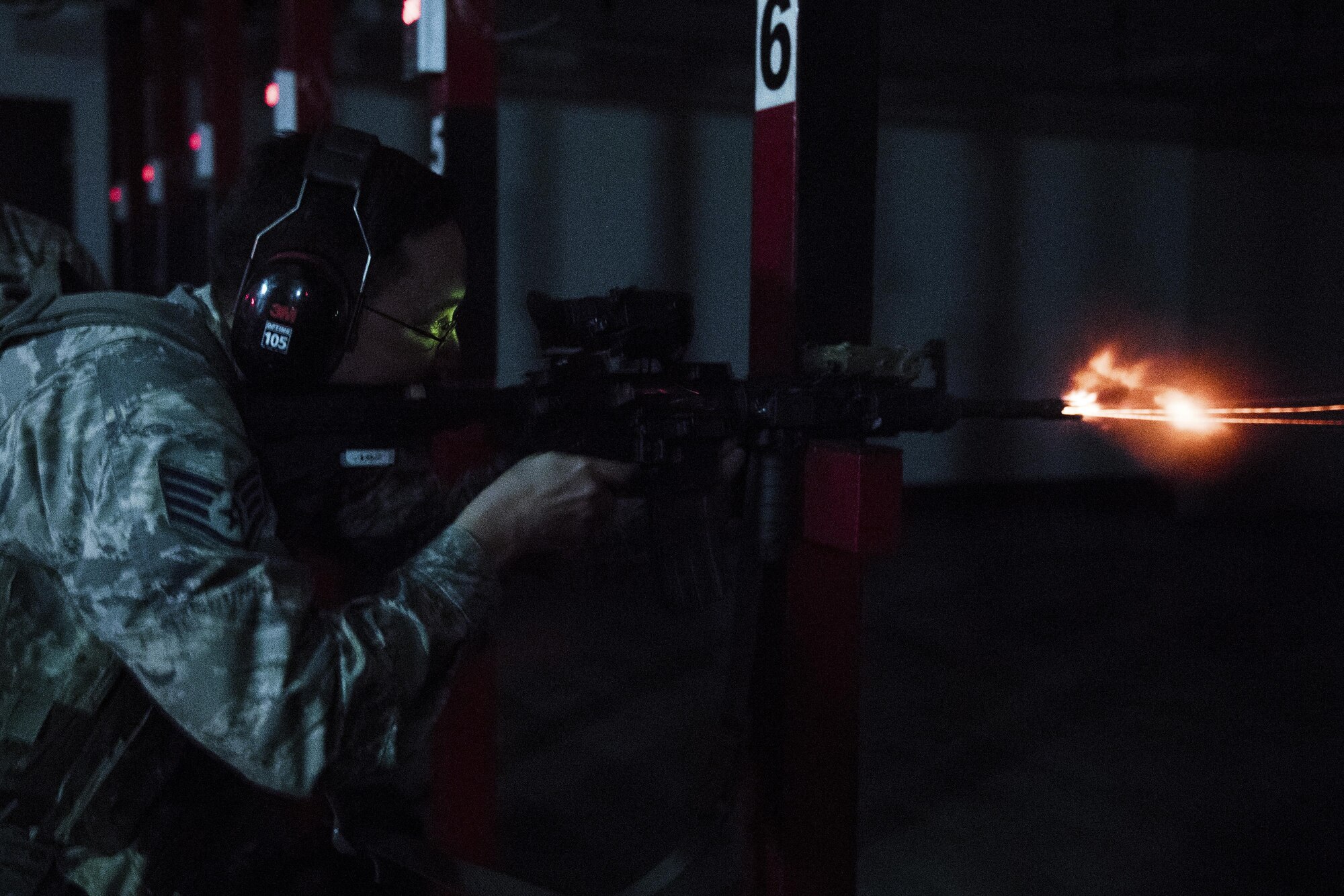 Airman 1st Class Parker McKenna, 374th Security Forces Squadron patrolman, fires an M-4 Carbine during a weapons qualification test at Yokota Air Base, Japan, Dec.1, 2016. In order to qualify for deployment in combat arms, each Airman must have at least a score of 44 out of 63 rounds to pass. (U.S. Air Force photo by Senior Airman Delano Scott/Released)
