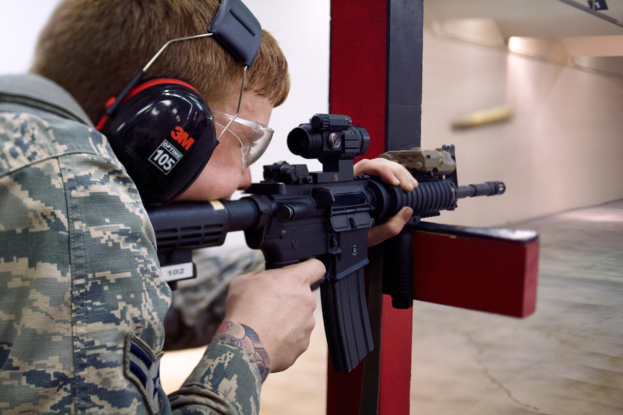 Airman 1st Class Ryan Privett, 374th Security Forces Squadron patrolman, fires an M-4 Carbine during a weapons qualification test at Yokota Air Base, Japan, Dec.1, 2016. In order to qualify for deployment in combat arms, each Airman must have at least a score of 44 out of 63 rounds to pass. (U.S. Air Force photo by Senior Airman Delano Scott/Released)