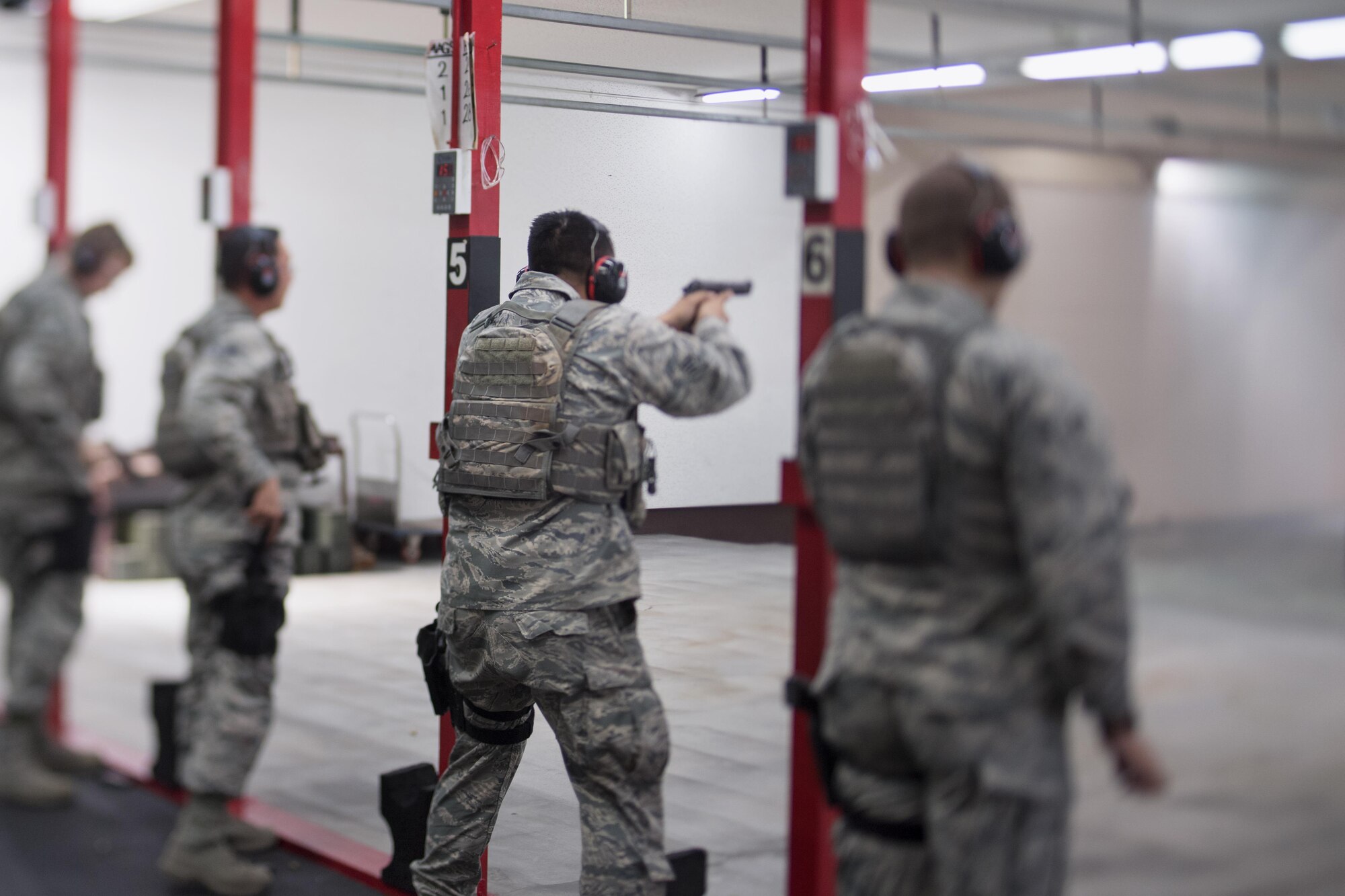 Airmen from the 374th Security Forces Squadron fire M9 pistols during a qualification test at Yokota Air Base, Japan, Dec. 1, 2016. To meet minimum qualifications in order to pass the course, Airmen must demonstrate full knowledge of safety rules, procedures and characteristics of multiple weapons and types of ammunition, while also showing target accuracy firing the weapon. (U.S. Air Force photo by Senior Airman Delano Scott/Released)
