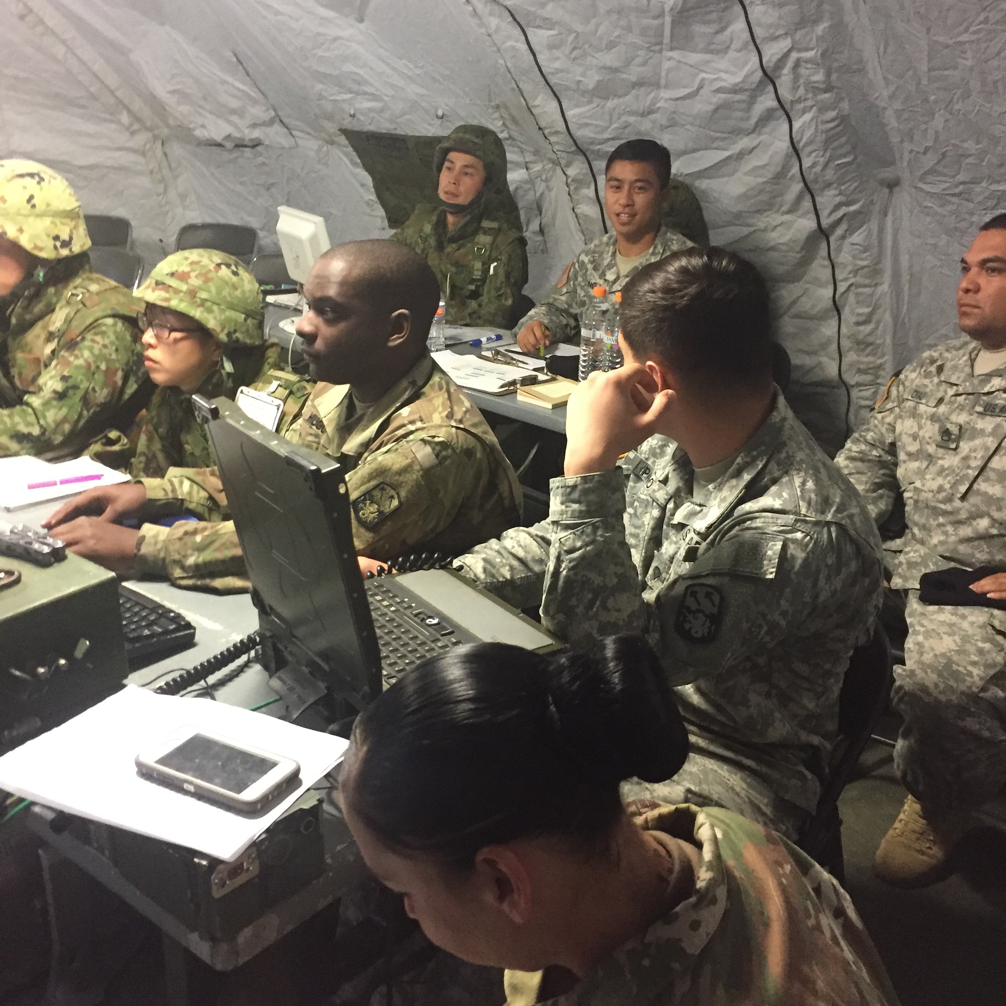 U.S. Army 1st. Lt. Theodore Fong, executive officer, Bravo Battery executive officer, 1st Battalion, 1st Air Defense Artillery Regiment, conducts bi-lateral track management during Exercise Keen Sword with Army Maj. Ryuzou Tamura, commander, 339 Battery commander, 8th Anti-Aircraft Artillery Group Nov. 7, 2016, at Marine Corps Air Station Iwakuni, Japan. Keen Sword is an annual event featuring combined training between U.S. and Japanese forces to exercise the methods created from Keen Edge. (courtesy photo) 