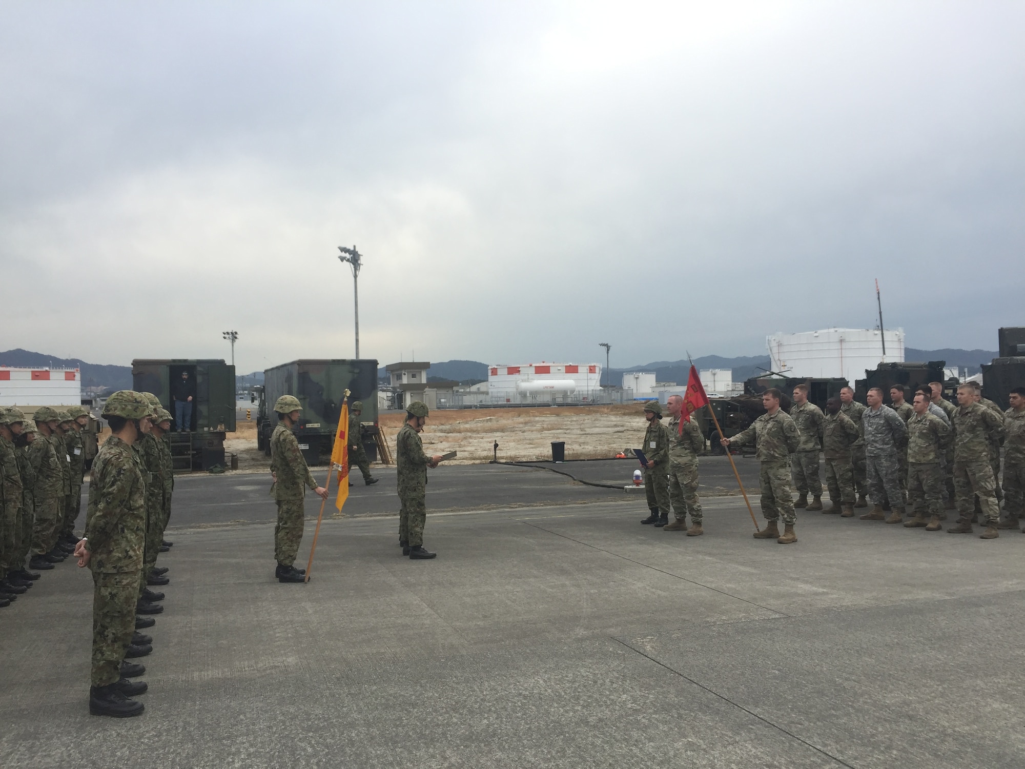 U.S. Army Capt. Thaddeus Morris, Bravo Battery commander, 1st Battalion, 1st Air Defense Artillery Regiment, represents his unit during Keen Sword 17 at the closing ceremony with 339 Battery, 8th Anti-Aircraft Artillery Group Nov. 10, 2016, at Marine Corps Air Station Iwakuni, Japan. Keen Sword is an annual event featuring combined training between U.S. and Japanese forces. (courtesy photo) 