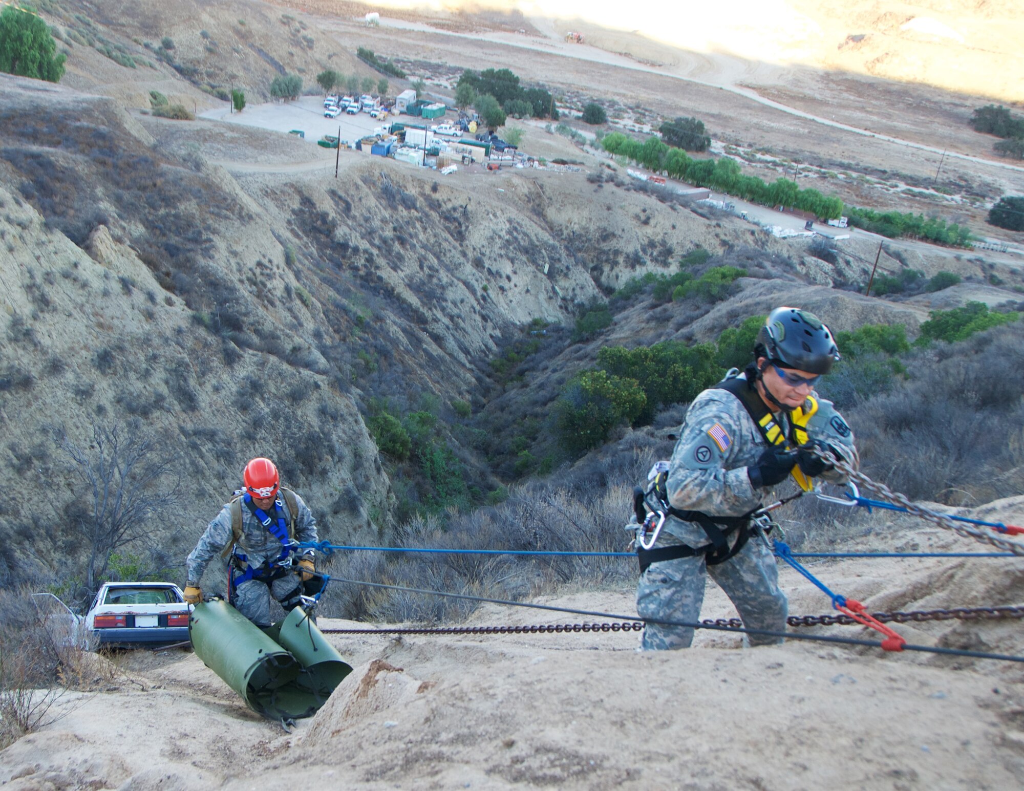 A Hawaii Air Natioanl Guard Airmen and Hawaii Army National Guard Soldier repel down a cliff to a car wreck prop during a cliff rescue scenario at Exercise Vigilant Guard 2017, Delle Valle Regional Center, California, Nov. 17, 2016. The service members are part of a Hawaii Natonal Guard team that focuses on emergency response. Vigilant Guard is an exercise program sponsored by United States Northern Command in conjunction with National Guard Bureau to provide State National Guards an opportunity to improve cooperation and relationships with their regional civilian, military, and federal partners in preparation for emergencies and catastrophic events. (U.S. Air National Guard photo by Senior Airman Orlando Corpuz) 