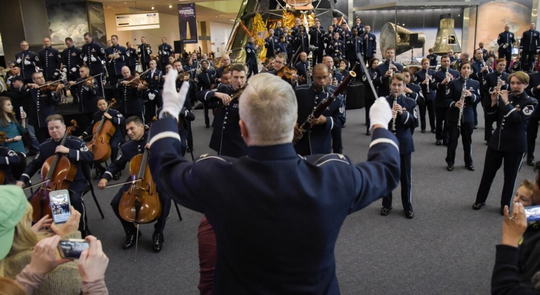 U.S. Air Force Band Commander Col. Larry H. Lang conducts the band's annual holiday flash mob performance at the Smithsonian National Air and Space Museum in Washington, D.C., Nov. 29, 2016. (U.S. Air Force photo by Jim Varhegyi)
