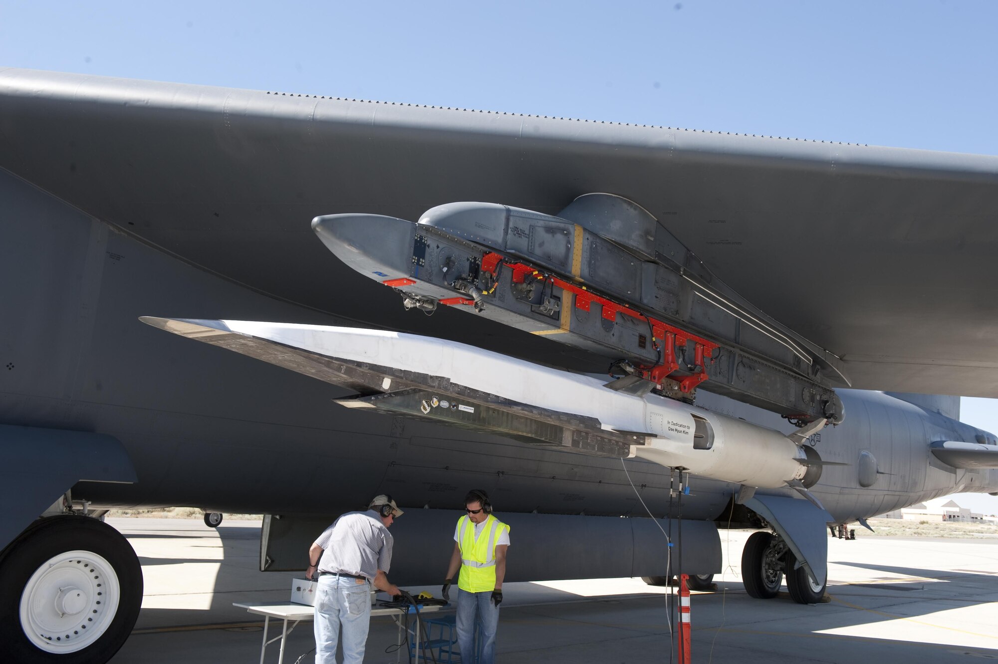 Ground crew members make the final checks to the X-51A Waverider scramjet, which is affixed to an Edwards B-52H Stratofortress before being flown over the Pacific Ocean and launched June 13, 2011. (Photo by Bob Ferguson/Boeing)