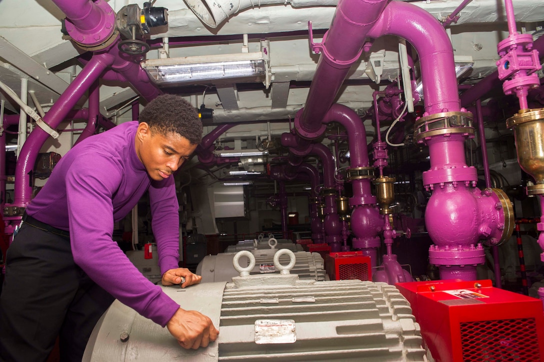 Navy Petty Officer 3rd Class Daniel Lewis screws bolts into a service pump in the forward fuel pump room aboard the USS Dwight D. Eisenhower in the Red Sea, Nov. 30, 2016. The aircraft carrier is supporting Operation Inherent Resolve and other security efforts in the U.S. 5th Fleet area of responsibility. Navy photo by Seaman Neo Greene III