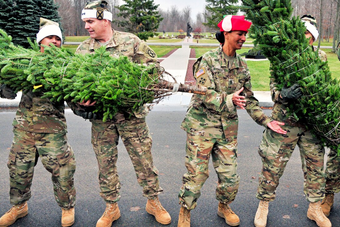 Soldiers unload a shipment of Christmas trees at Fort Drum, N.Y., Dec. 1, 2016. The trees were distributed to Fort Drum soldiers as part of the "Trees for Troops" program. Army photo by Spc. Liane Schmersahl