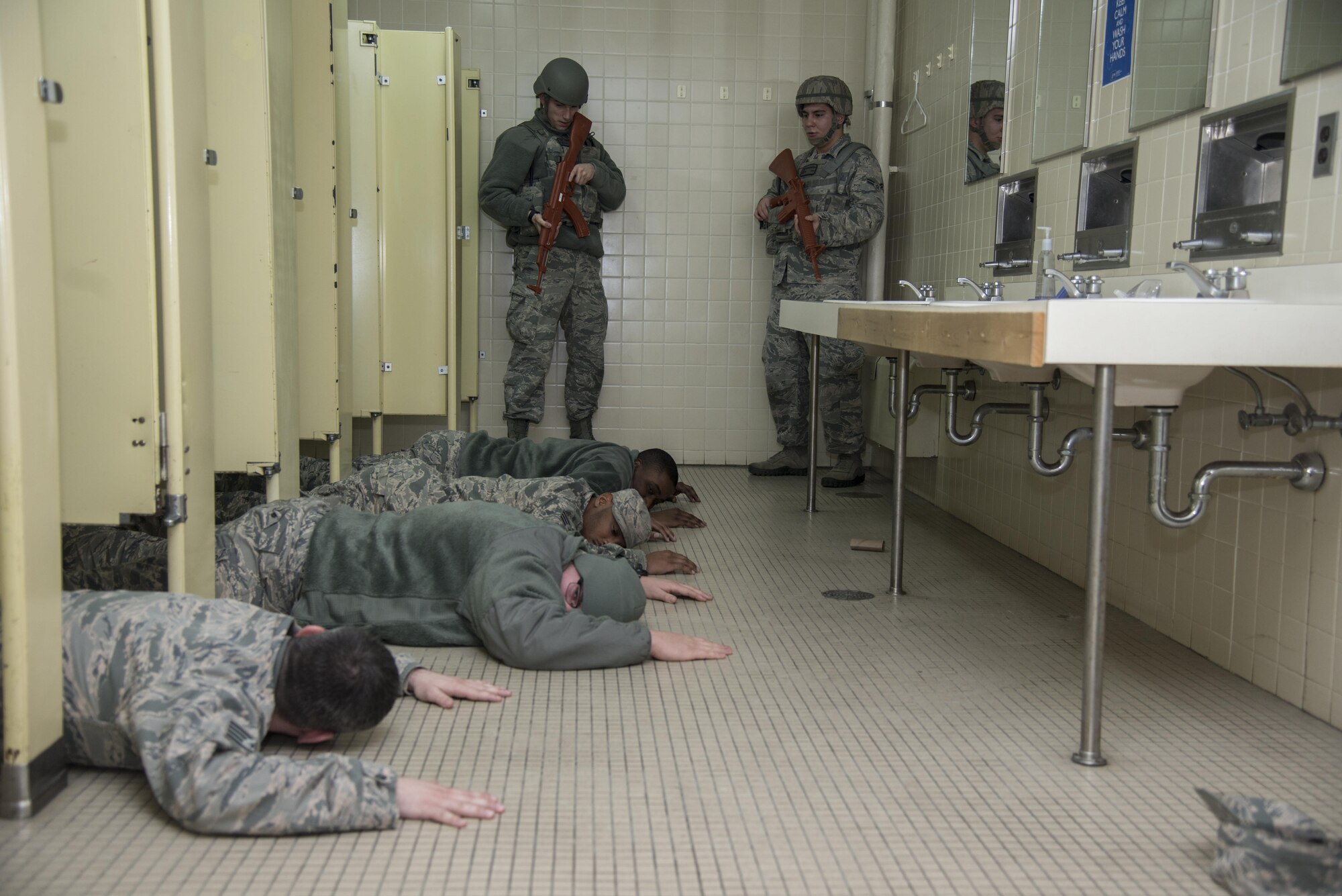 Airmen lay facedown on the floor during an active-shooter exercise at Misawa Air Base, Japan, Dec. 02, 2016. Exercise Beverly Sunrise 17-01 was held to evaluate the fighter wing's ability to correctly notify the base population of an active shooter in a timely manner and effectively report unit accountability. (U.S. Air Force Senior Airman Brittany A. Chase)