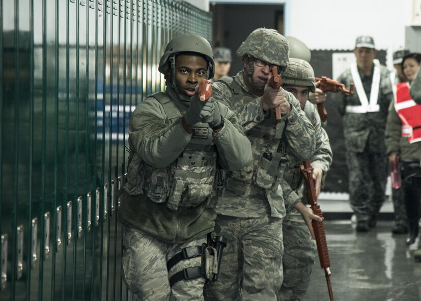 A team of 35th Security Forces Squadron members clear a building at Misawa Air Base, Japan, Dec. 2, 2016. Exercise Beverly Sunrise 17-01 was a base-wide exercise held to test base safety and security in case of a real-world scenario. (U.S. Air Force photo by Senior Airman Brittany A. Chase)