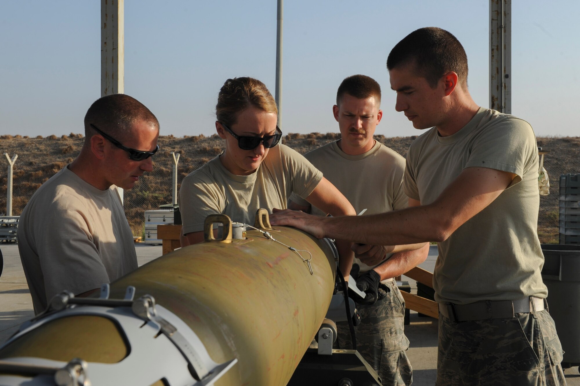 U.S. Air Force Airmen assigned to the 447th Expeditionary Aircraft Maintenance Squadron, attach the tail section of a GBU-54 Laser Joint Direct Attack Munition bomb Oct. 29, 2016, at Incirlik Air Base, Turkey. The Airmen are all Munitions Systems specialists, responsible for assembling and processing of munitions. (U.S. Air Force photo by Airman 1st Class Devin M. Rumbaugh)