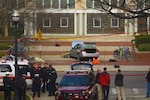 Local and federal authorities surround the attacker's car that hit multiple students outside of Watts Hall at Ohio State University in Columbus, Ohio, Nov. 28, 2016. A group of former and current military members helped secure one of the university's classrooms during a campus-wide lockdown after the attack. 