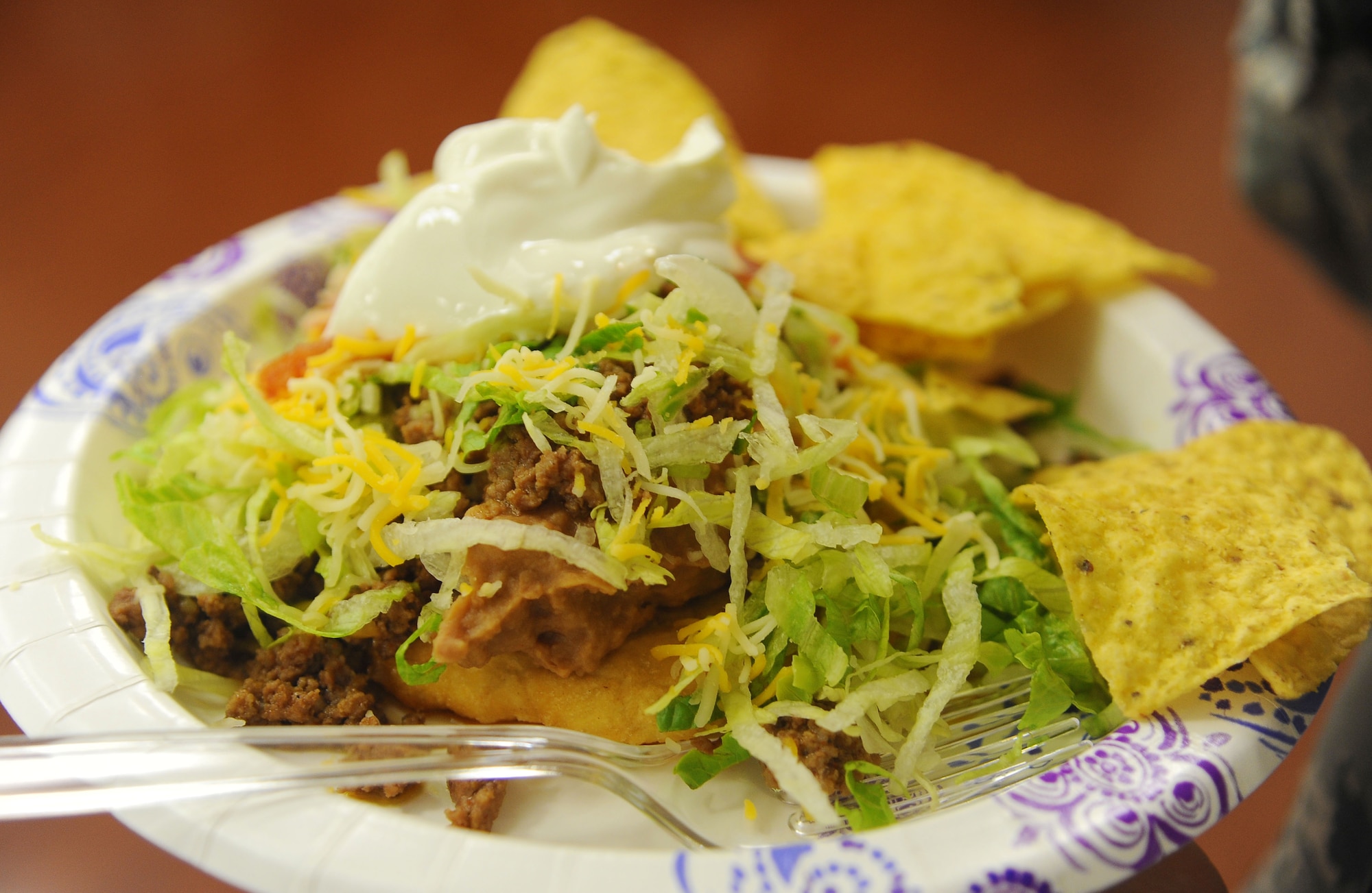 A fry bread taco sits on a plate during a Native American Heritage month luncheon at MacDill Air Force Base, Fla., Nov. 29, 2016. Fry bread tacos were one of the foods served at the luncheon and are a common food among many tribes. (U.S. Air Force photo by Airman 1st Class Adam R. Shanks)