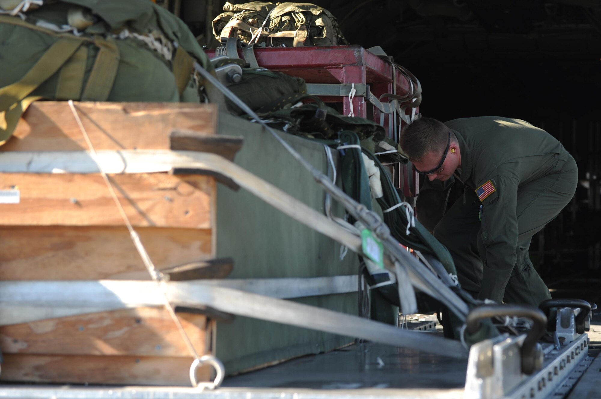 A loadmaster from the 913th Airlift Group transfers cargo onto a C-130J as part of the Turkey Shoot competition Nov. 17, 2016, at Little Rock Air Force Base, Ark. The Turkey Shoot is a premier training exercise that puts members of flying units against each other in a friendly competition to hone combat airlift capabilities. (U.S. Air Force photo by Airman 1st Class Grace Nichols)