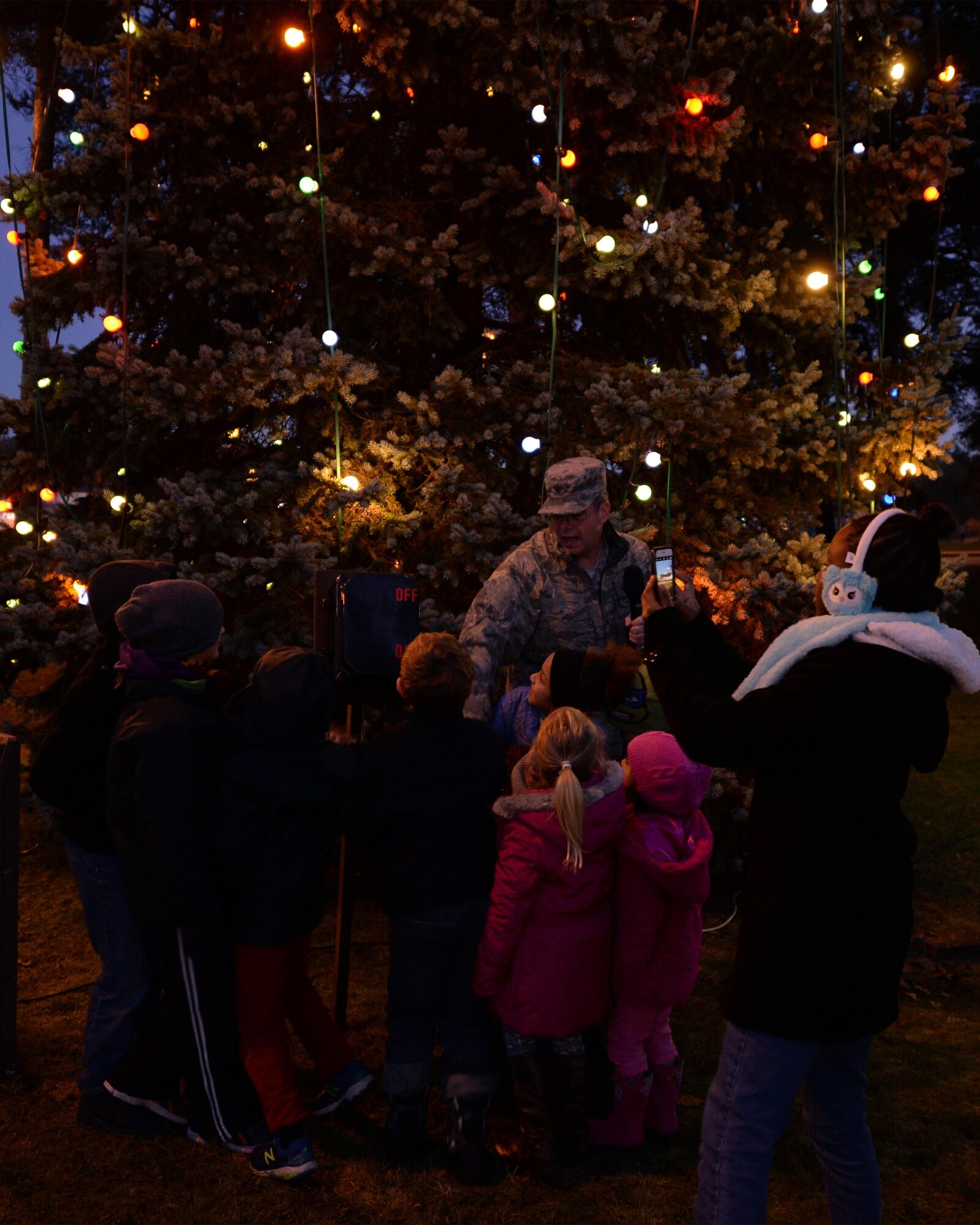 Brig. Gen. Richard G. Moore Jr., 86th Airlift Wing commander, and children from the Vogelweh community turn on the Christmas tree lights on Vogelweh Military Complex, Germany, Nov. 29, 2016. The tree lighting ceremony marked the beginning of the holiday season at Vogelweh. (U.S. Air Force photo by Senior Airman Jimmie D. Pike)