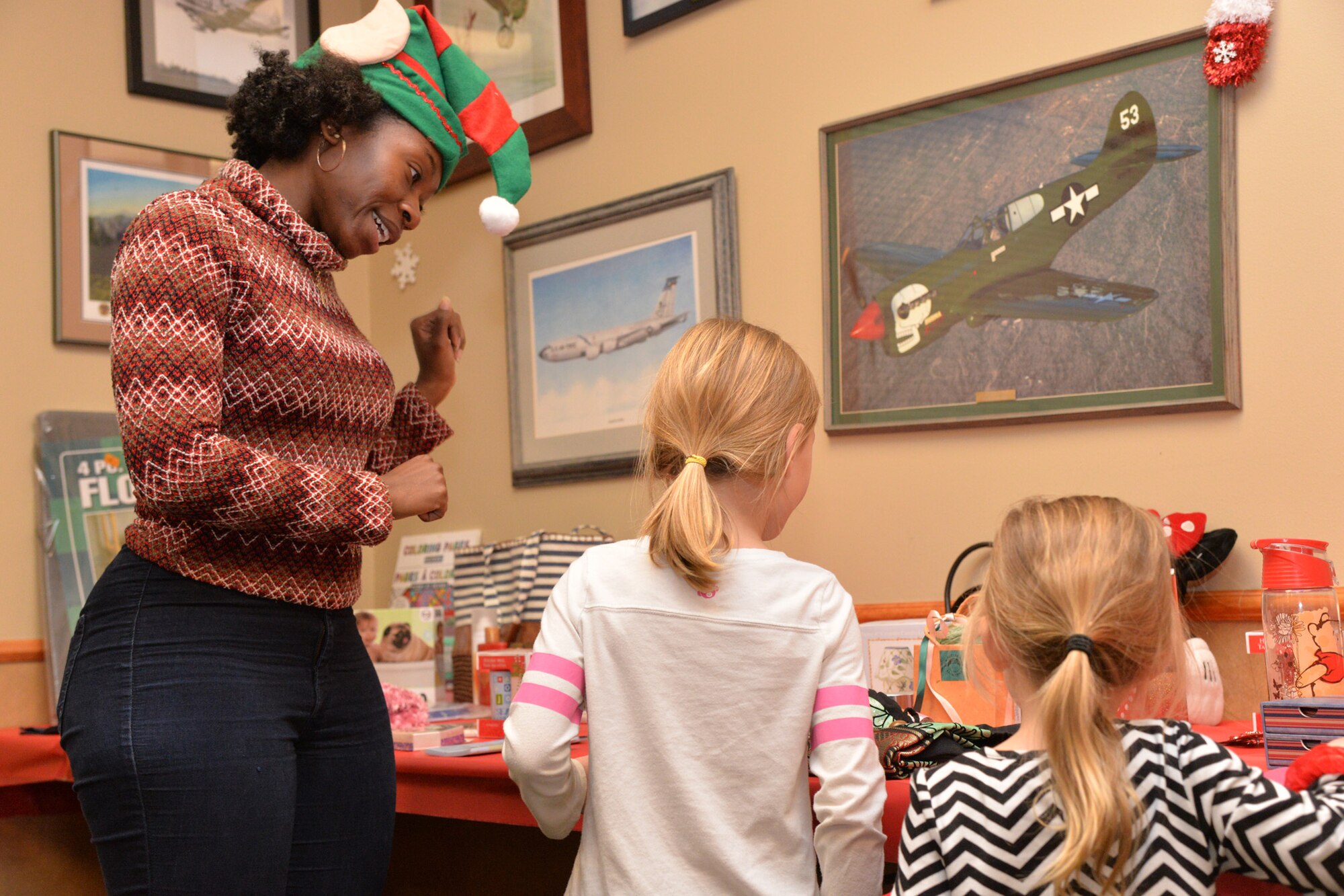 Airmen and their families kicked off the month of December with an Elf Mart and annual tree lighting ceremony at the Grizzly Bend Dec. 1, 2016, at Malmstrom Air Force Base, Mont. Children were able to pick out gifts for their families at the Elf Mart, make ornaments, and sit with the Clauses and all guests were able to enjoy refreshments as the tree was lit. (U.S. Air Force photo/Airman 1st Class Daniel Brosam)