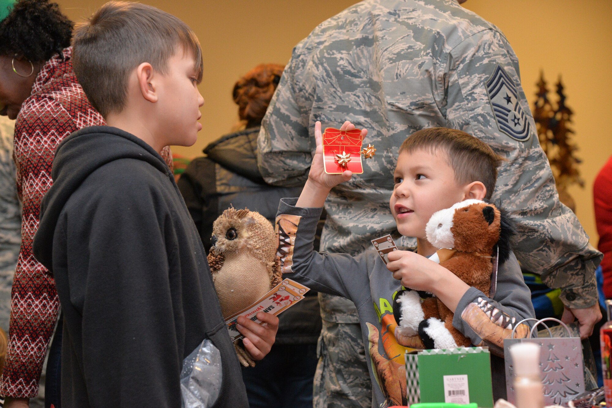 Airmen and their families kicked off the month of December with an Elf Mart and annual tree lighting ceremony at the Grizzly Bend Dec. 1, 2016, at Malmstrom Air Force Base, Mont. Children were able to pick out gifts for their families at the Elf Mart, make ornaments, and sit with the Clauses and all guests were able to enjoy refreshments as the tree was lit. (U.S. Air Force photo/Airman 1st Class Daniel Brosam)