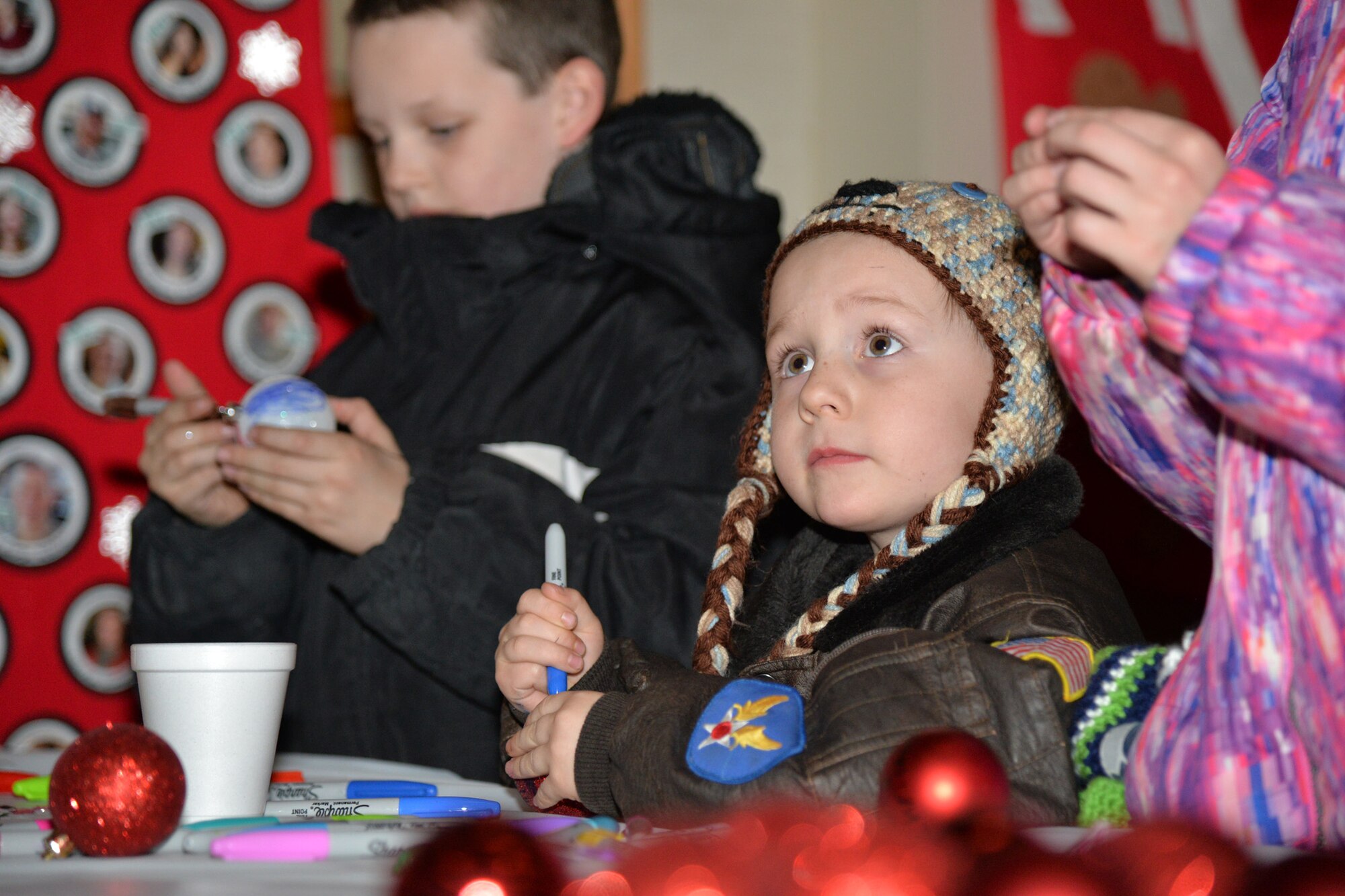 Airmen and their families kicked off the month of December with an Elf Mart and annual tree lighting ceremony at the Grizzly Bend Dec. 1, 2016, at Malmstrom Air Force Base, Mont. Children were able to pick out gifts for their families at the Elf Mart, make ornaments, and sit with the Clauses and all guests were able to enjoy refreshments as the tree was lit. (U.S. Air Force photo/Airman 1st Class Daniel Brosam)