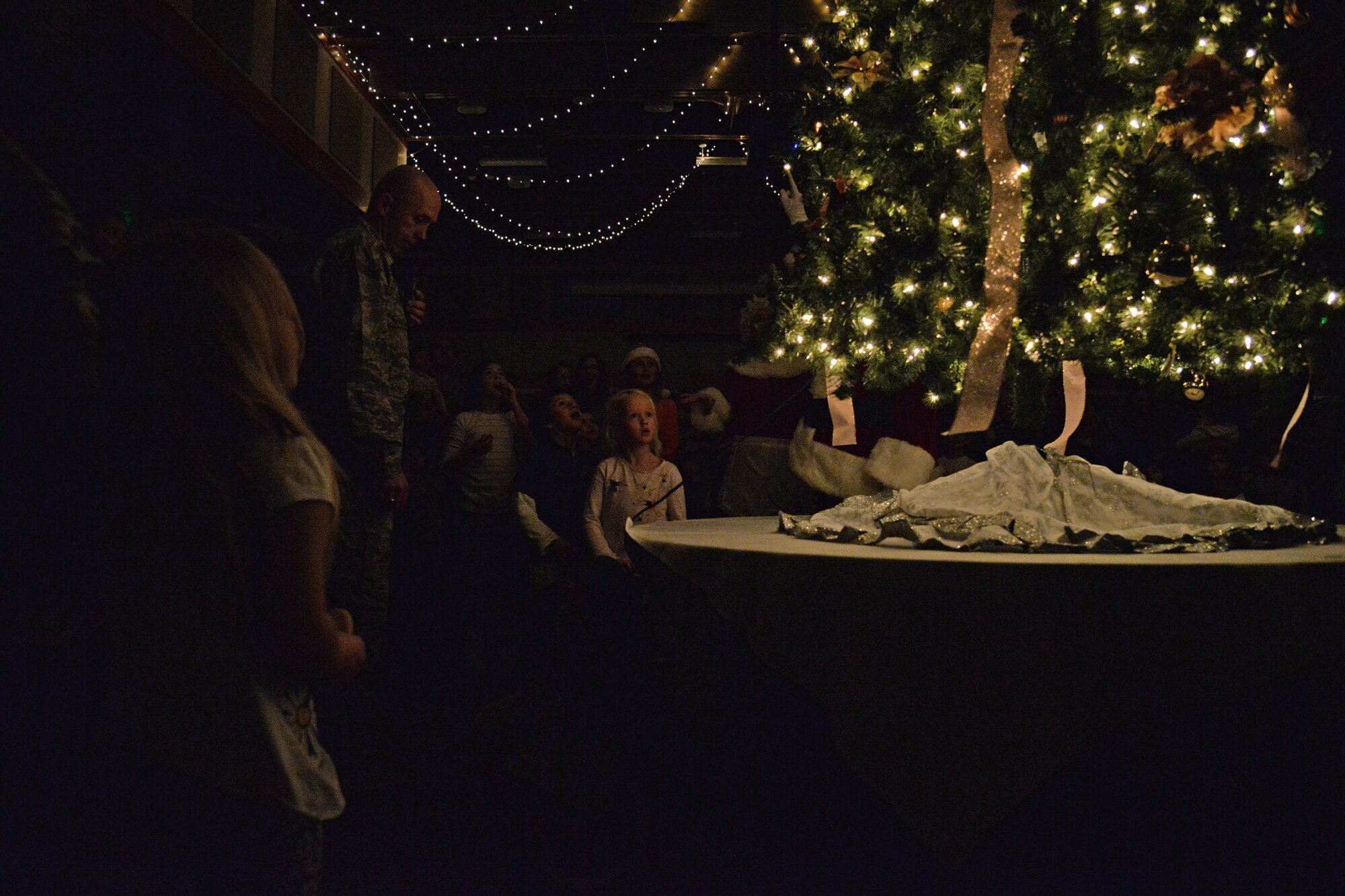 Airmen and their families kicked off the month of December with an Elf Mart and annual tree lighting ceremony at the Grizzly Bend Dec. 1, 2016, at Malmstrom Air Force Base, Mont. Children were able to pick out gifts for their families at the Elf Mart, make ornaments, and sit with the Clauses and all guests were able to enjoy refreshments as the tree was lit. (U.S. Air Force photo/Airman 1st Class Daniel Brosam)