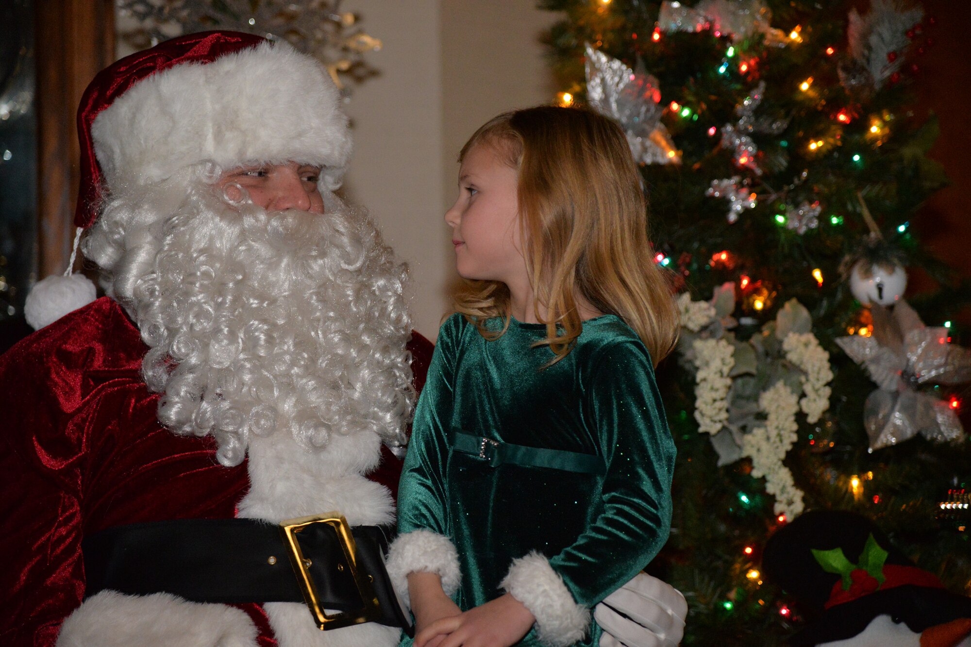 Airmen and their families kicked off the month of December with an Elf Mart and annual tree lighting ceremony at the Grizzly Bend Dec. 1, 2016, at Malmstrom Air Force Base, Mont. Children were able to pick out gifts for their families at the Elf Mart, make ornaments, and sit with the Clauses and all guests were able to enjoy refreshments as the tree was lit. (U.S. Air Force photo/Airman 1st Class Daniel Brosam)