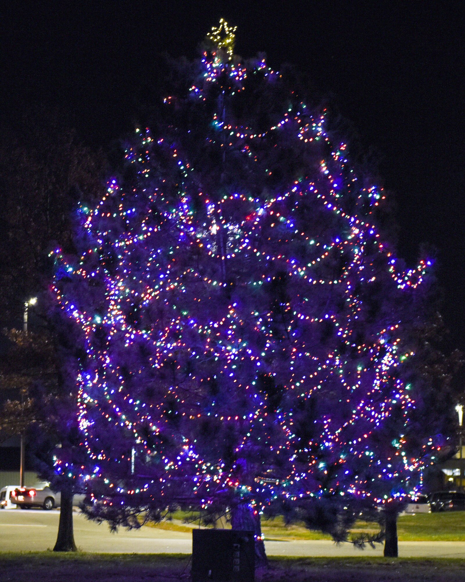 The holiday tree glows in front of the Mission’s End Club during the annual tree lighting event at Whiteman Air Force Base, Mo., Nov. 29, 2016. Approximately 1,400 people attended the wizard-themed event that kicked off the holidays in a magical way.